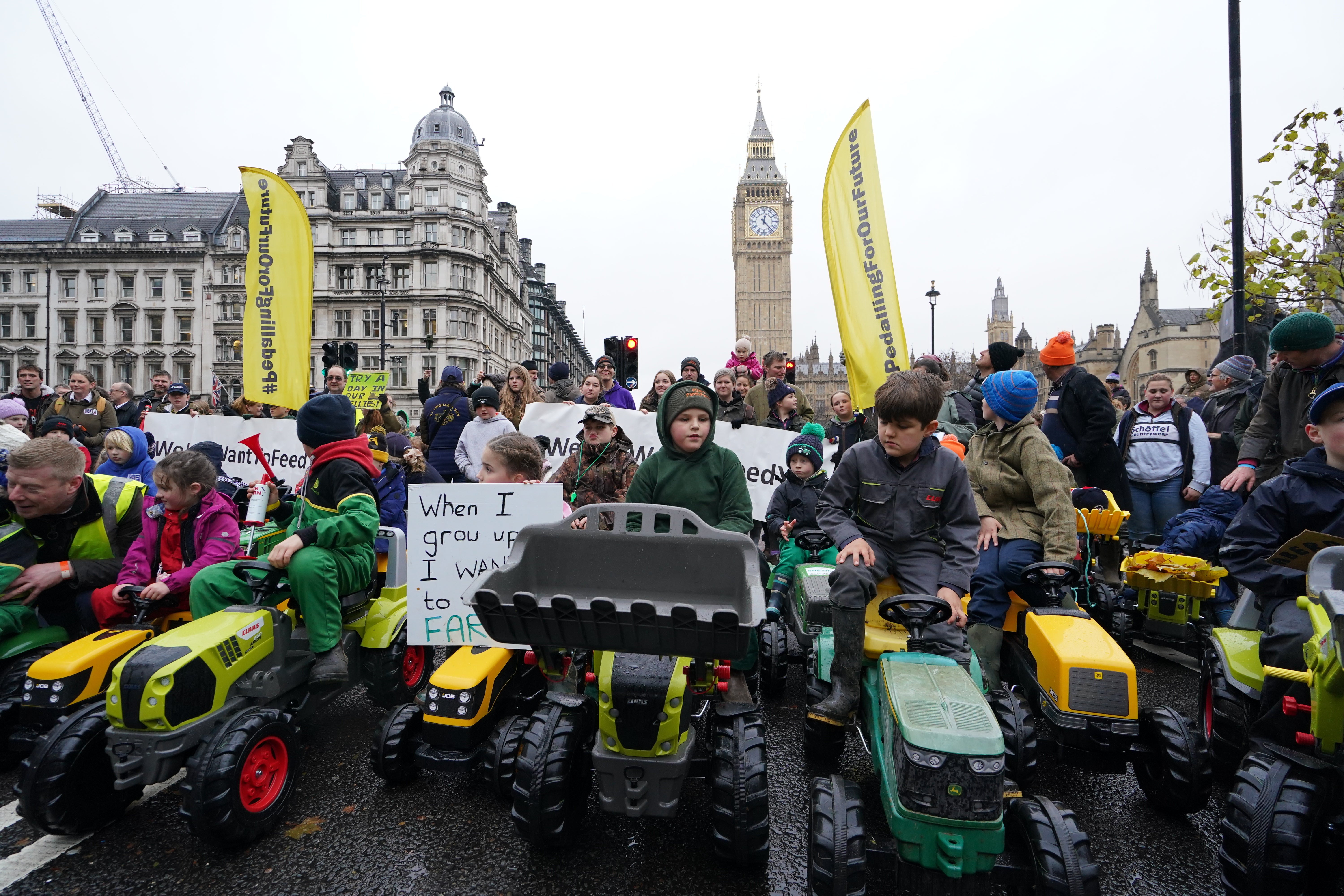 Children on toy tractors during a farmers protest in central London (Gareth Fuller/PA)