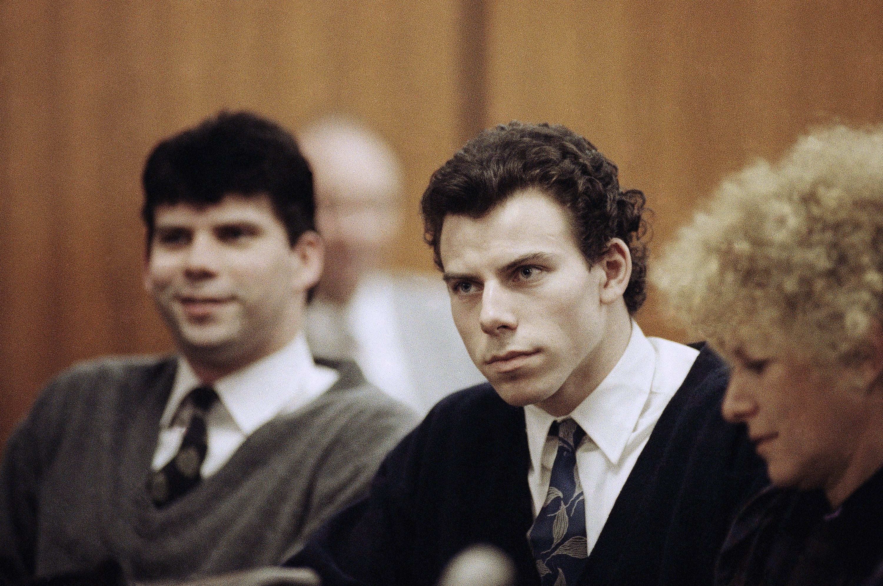 Lyle, left, and Erik Menendez sit with defense attorney Leslie Abramson, right, during a court hearing on Nov. 26, 1990