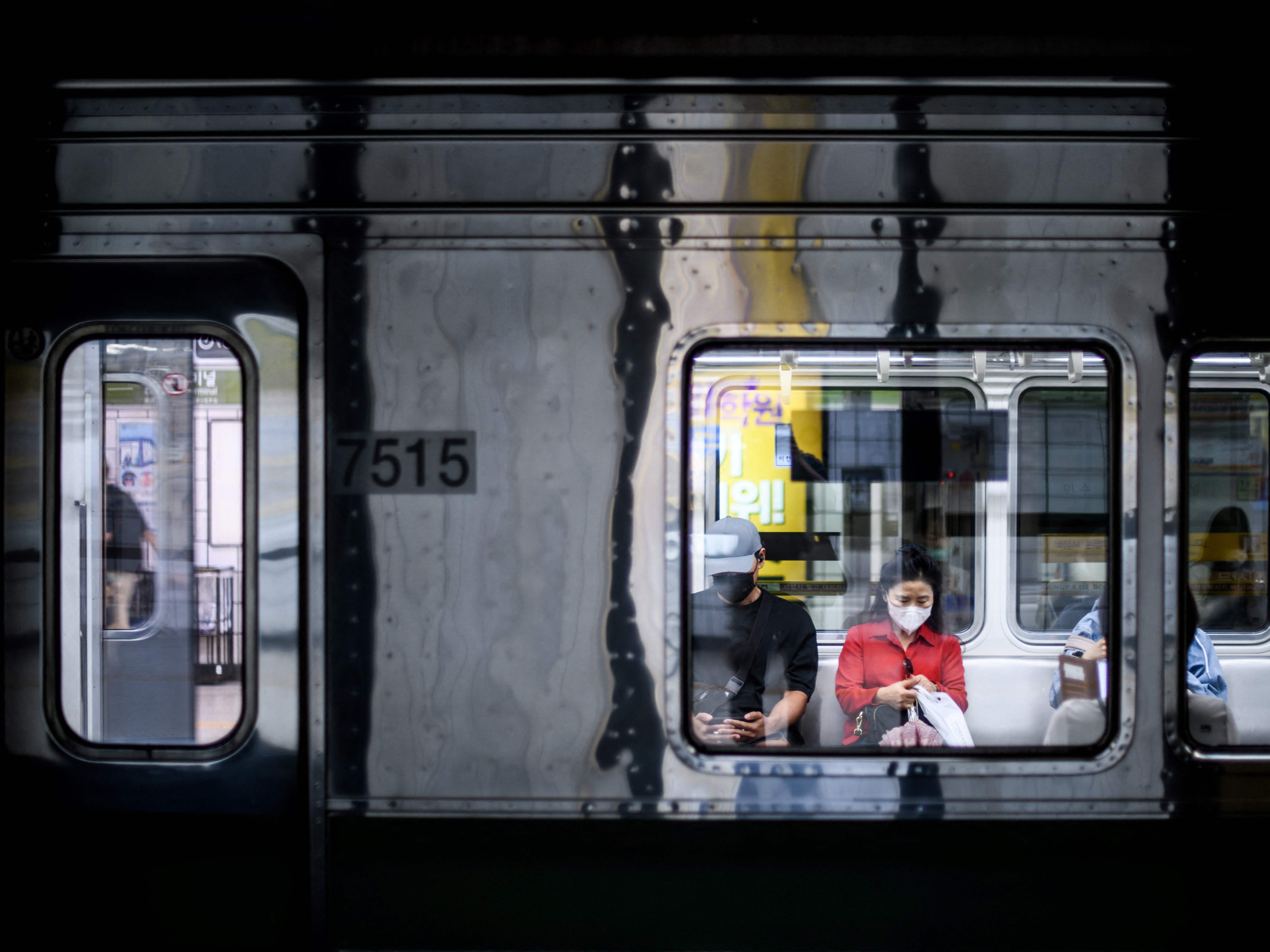 File. Commuters on an underground metro train in Seoul, South Korea