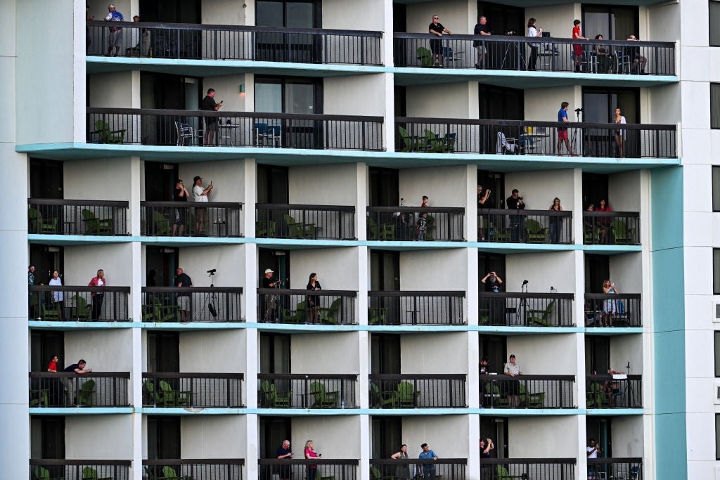 People watch from their balconies as the SpaceX Starship lifts off from Starbase near Boca Chica, Texas, on 19 November, 2024, for the Starship Flight 6 test