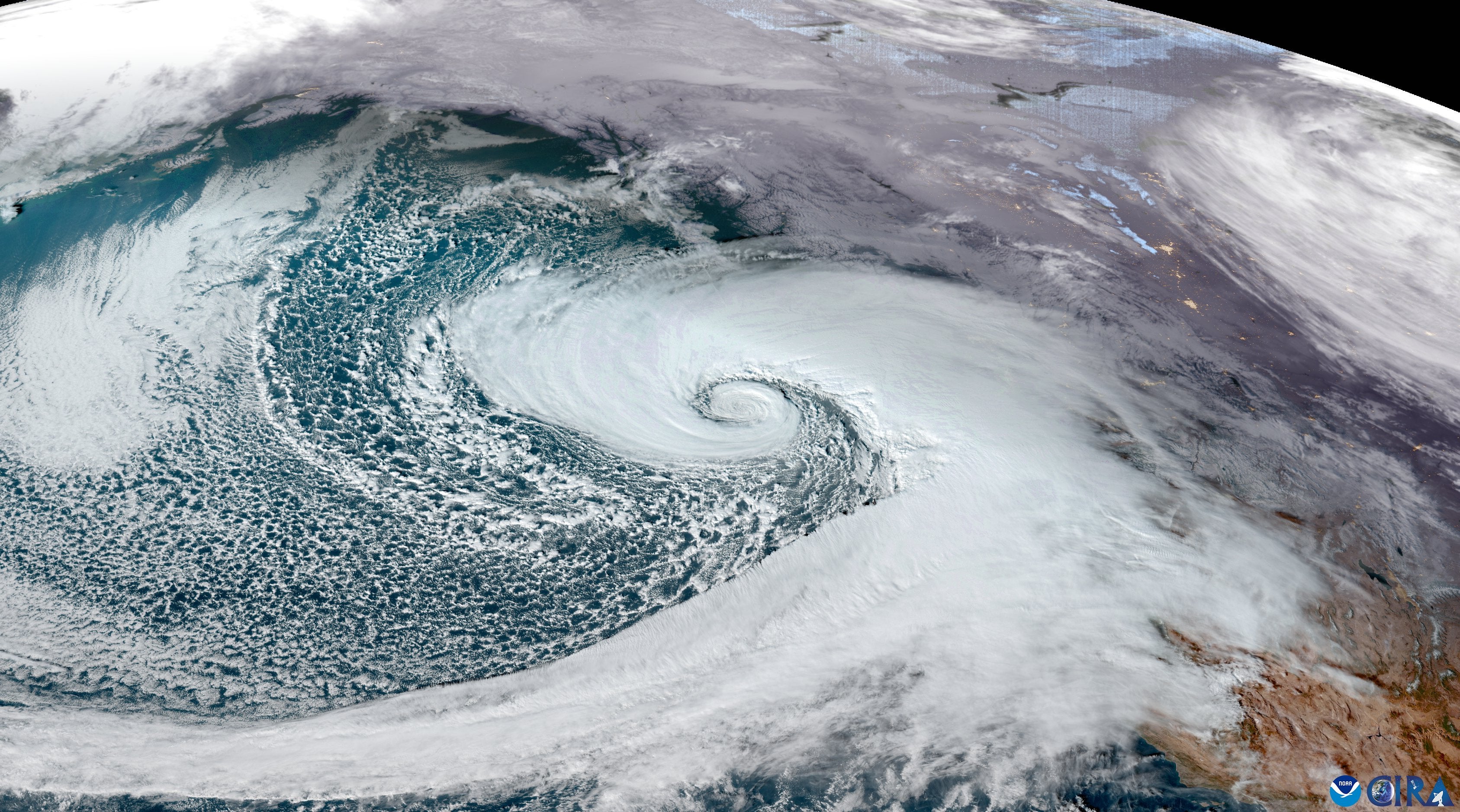 A high resolution satellite image shows the bomb cyclone as the sun sets on Tuesday. The storms occur when their central pressure drops by at least 24 millibars in 24 hours