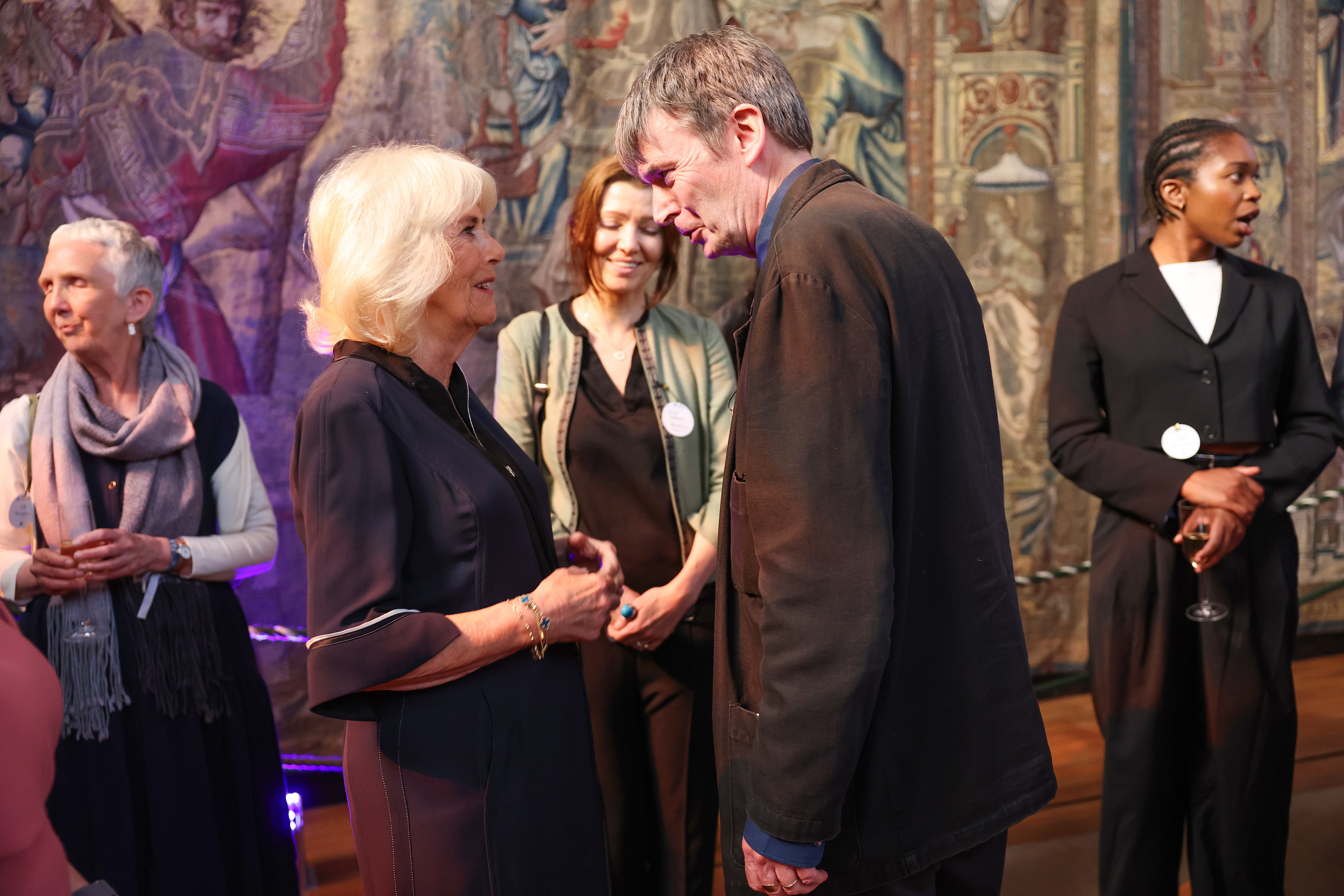 Queen Camilla speaks to Sir Ian Rankin during a reception with authors, actors and lovers of literature attending the Queen’s Reading Room Literary Festival at Hampton Court Palace in June