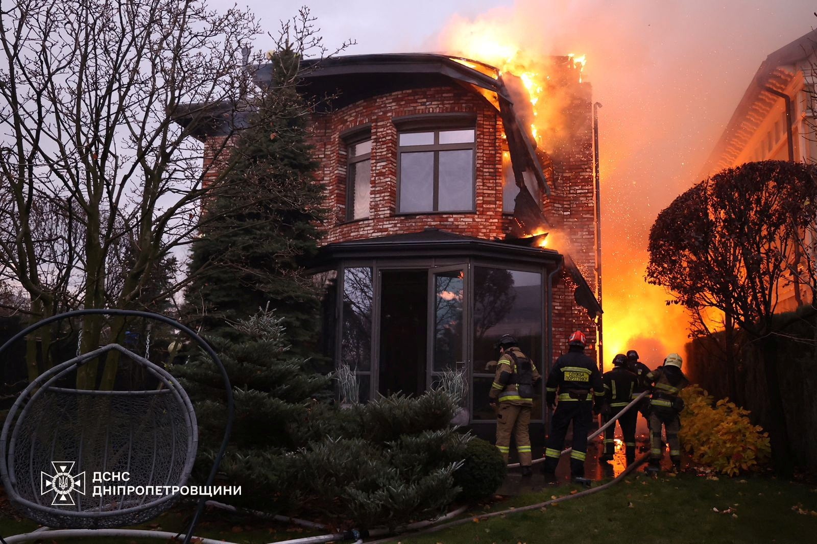 Firefighters put out a fire in Dnipro, central Ukraine, following Russia’s use of an IRBM missile