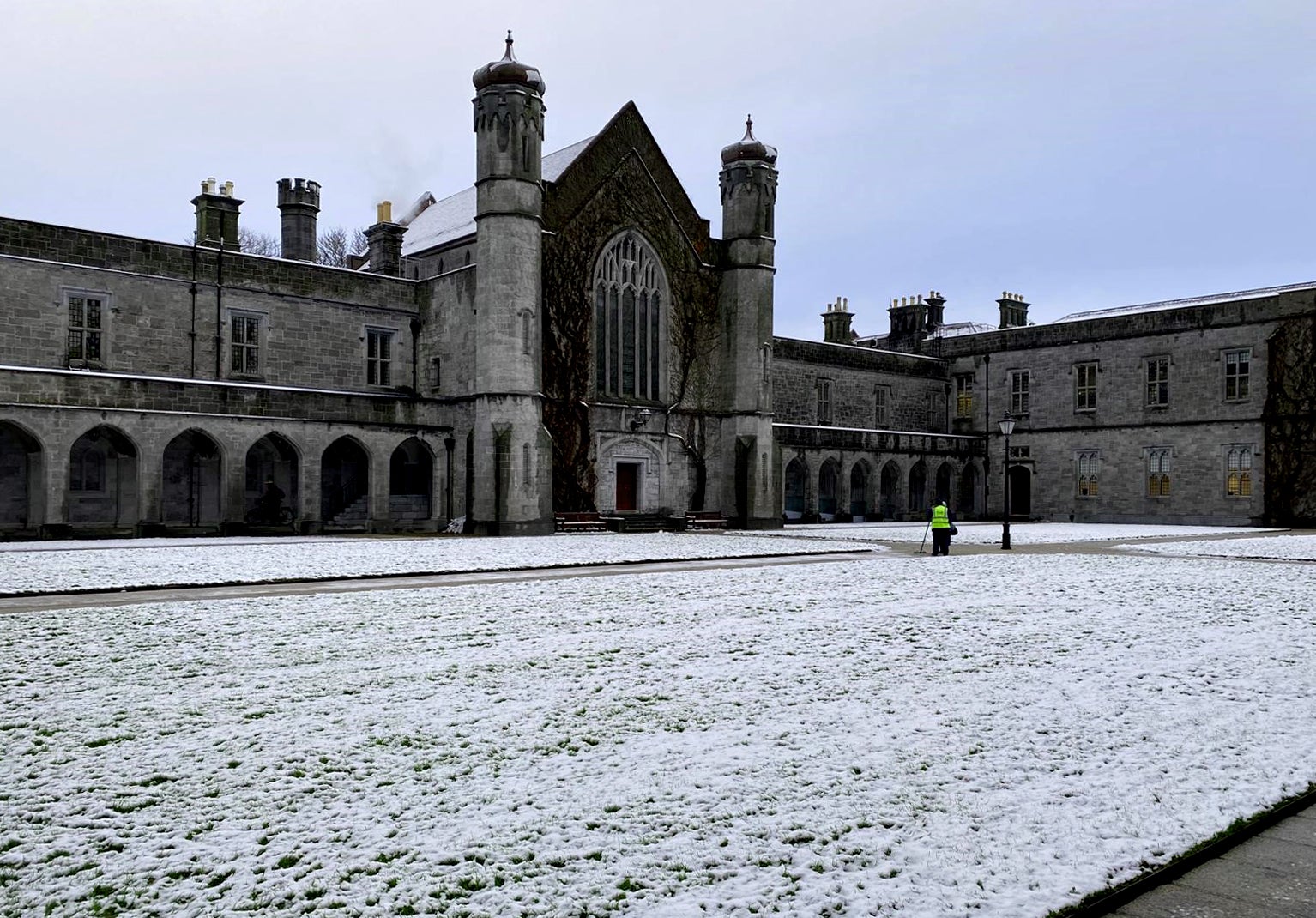 Staff at the University of Galway clear snow from pathways in the university's Quad