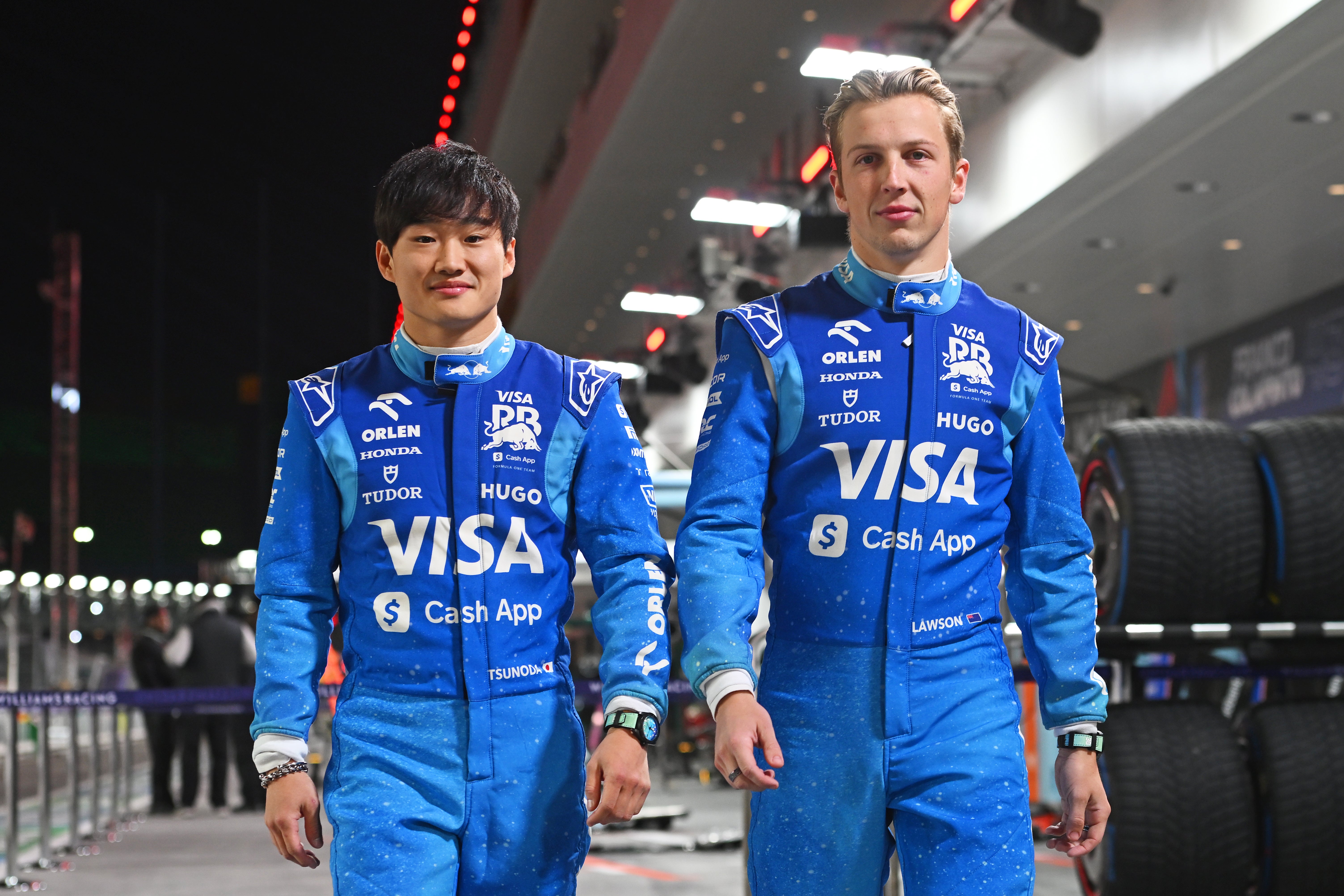 Tsunoda alongside RB teammate Liam Lawson in the Vegas paddock on Wednesday night