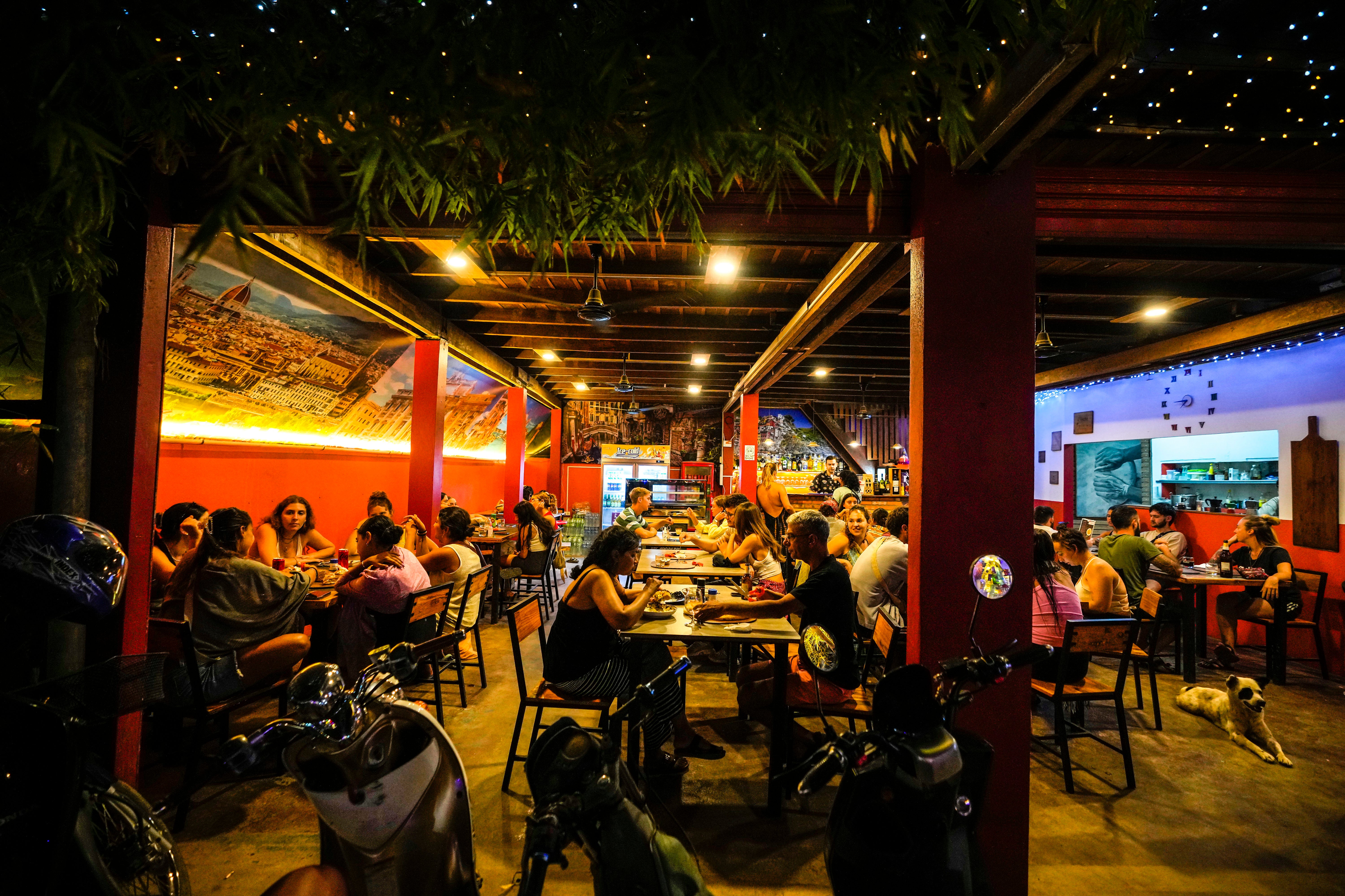 Foreign tourists have a drink in Vang Vieng, where there are concerns over a number of people who have fallen unwell