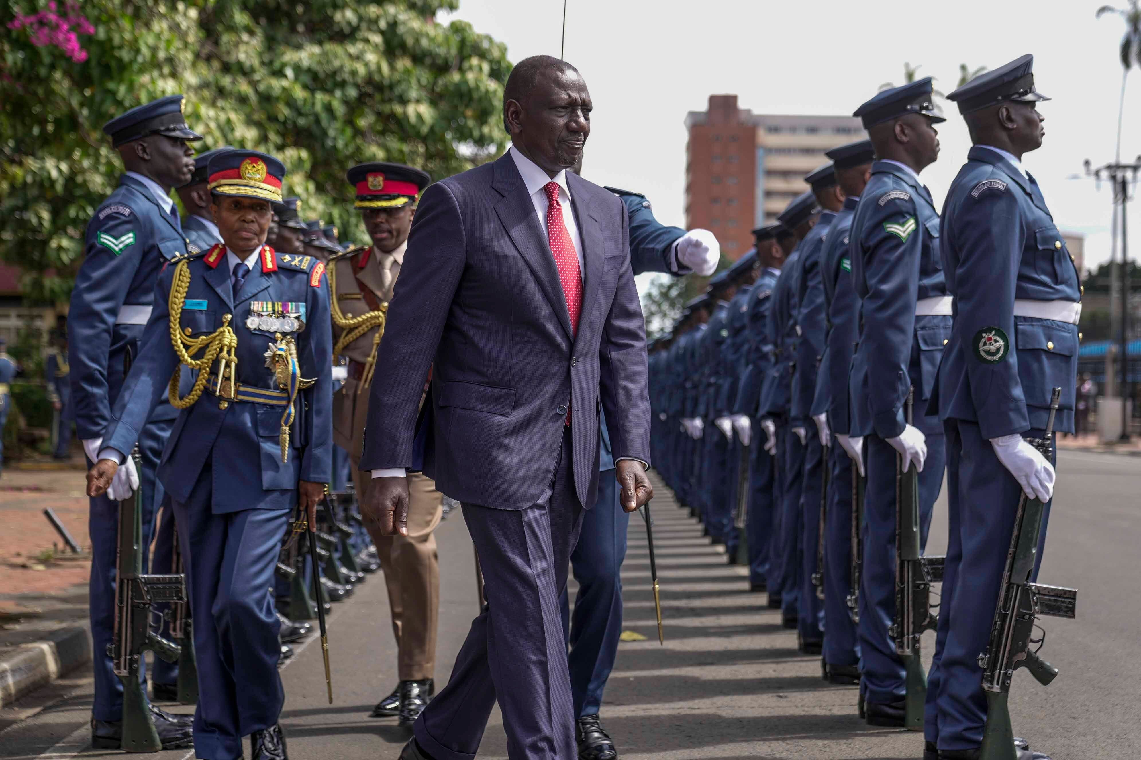 Kenyan President William Ruto, center, reviews a honour guard after arriving to give the State of The Nation address at Parliament buildings in Nairobi, Kenya Thursday, Nov. 21, 2024. (AP Photo/Brian Inganga)