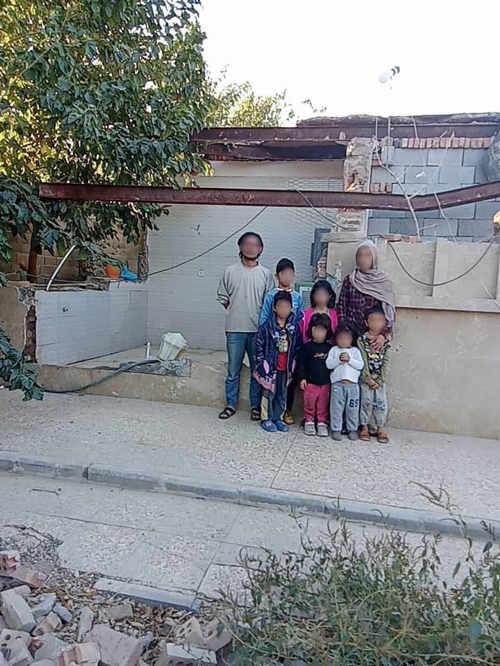 Abdul Rahim and his family outside their makeshift home in a disused factory