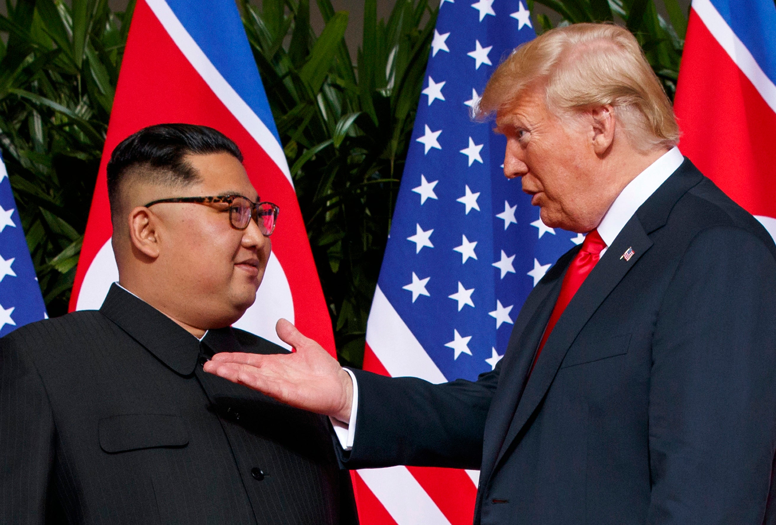 US president Donald Trump, right, meets with North Korean leader Kim Jong Un on Sentosa Island in Singapore, on 12 June 2018