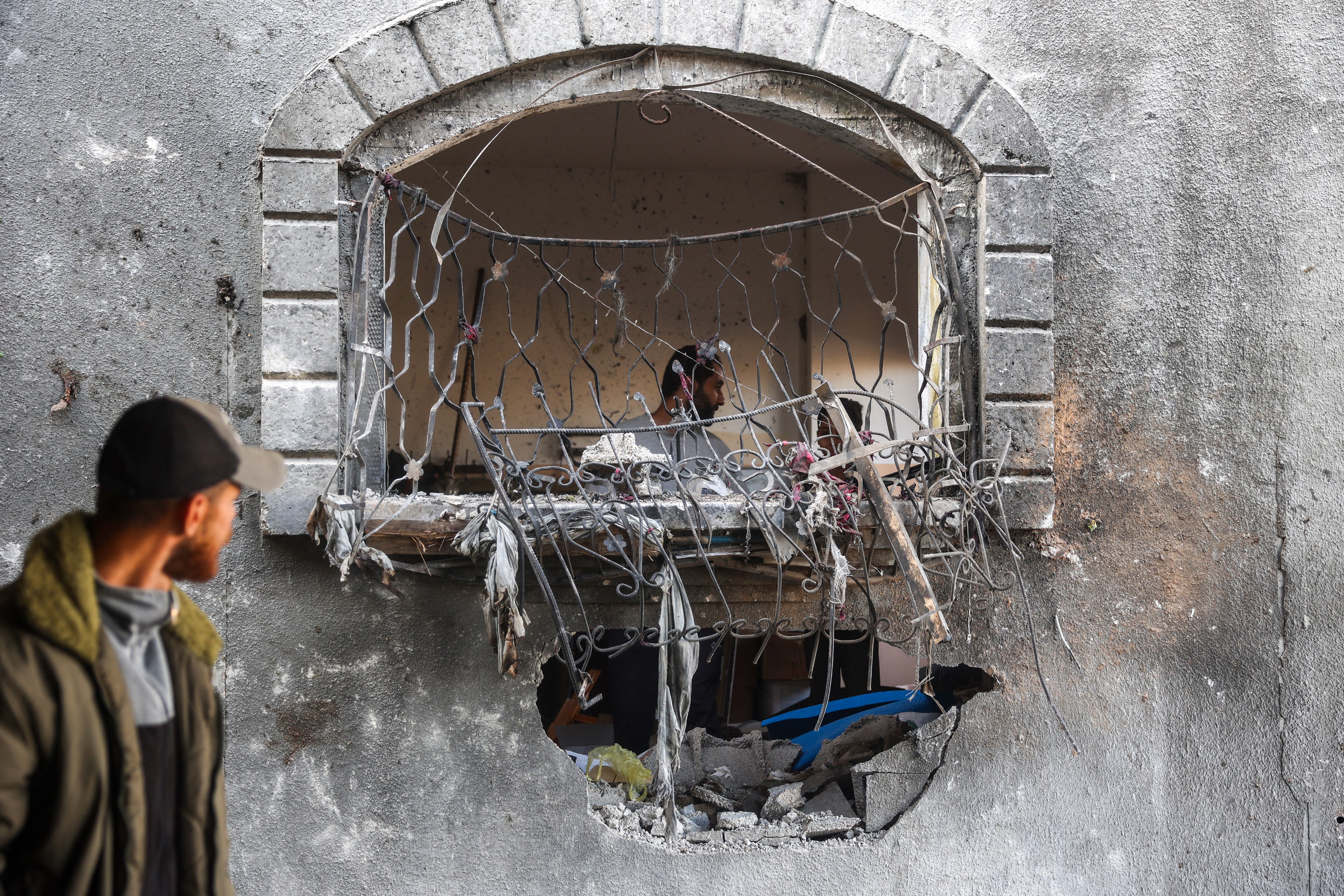 Men check the site on an Israeli strike at a house in Nuseirat in the central Gaza Strip on 22 November 2024