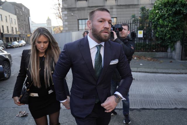 <p>Conor McGregor outside the High Court in Dublin with his fiancee Dee Devlin </p>