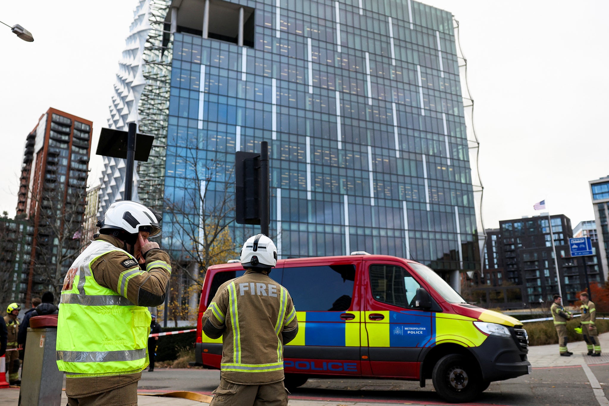 Firefighters stand outside the US embassy after a suspicious package was found last Friday