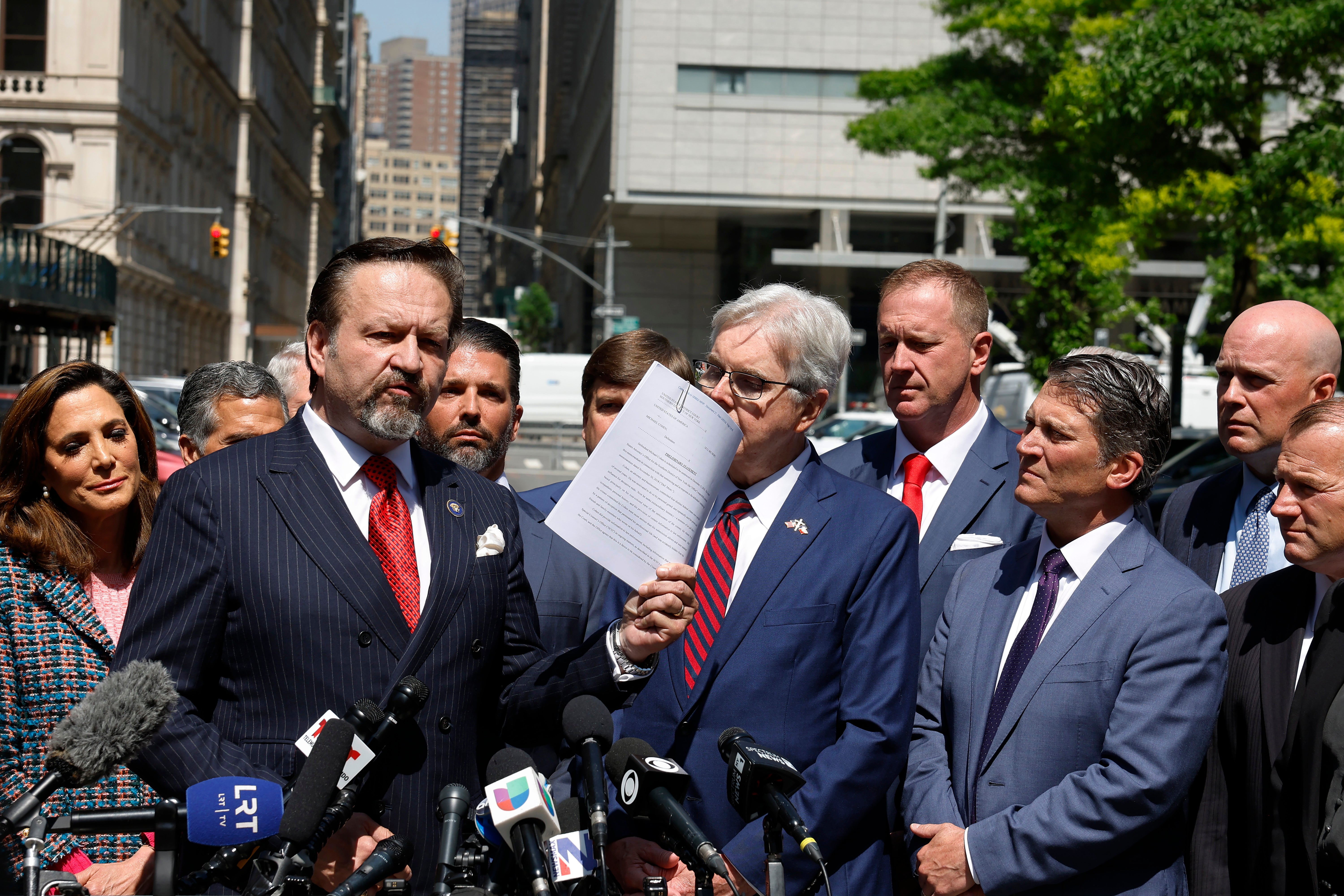 Former Trump White House advisor Sebastian Gorka (L) speaks during a press conference while on a break from former U.S. President Donald Trump's hush money trial outside Manhattan Criminal Court on May 21, 2024 in New York City