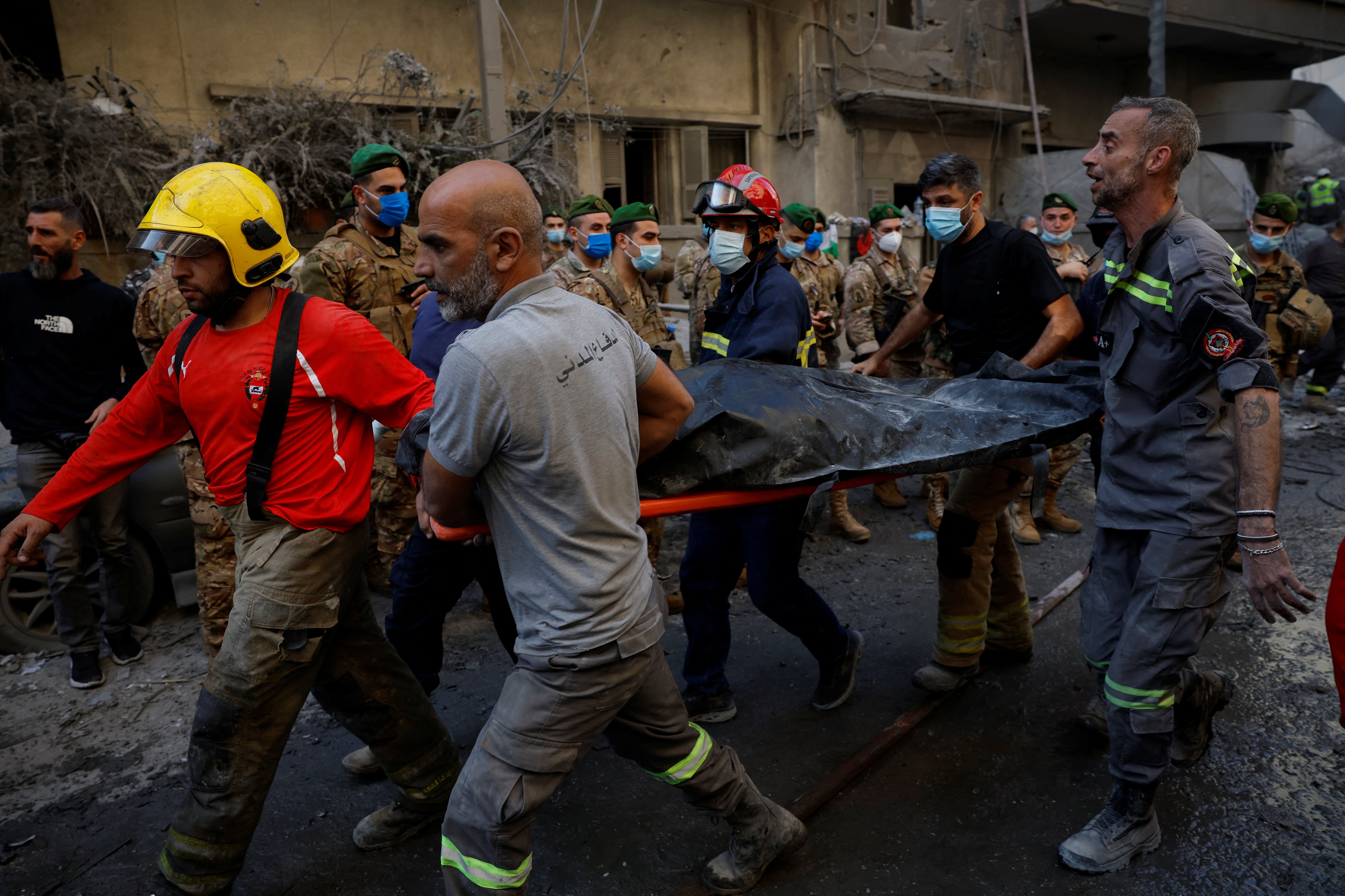 Civil defence members carry out a body from the site of an Israeli strike in Beirut's Basta neighbourhood