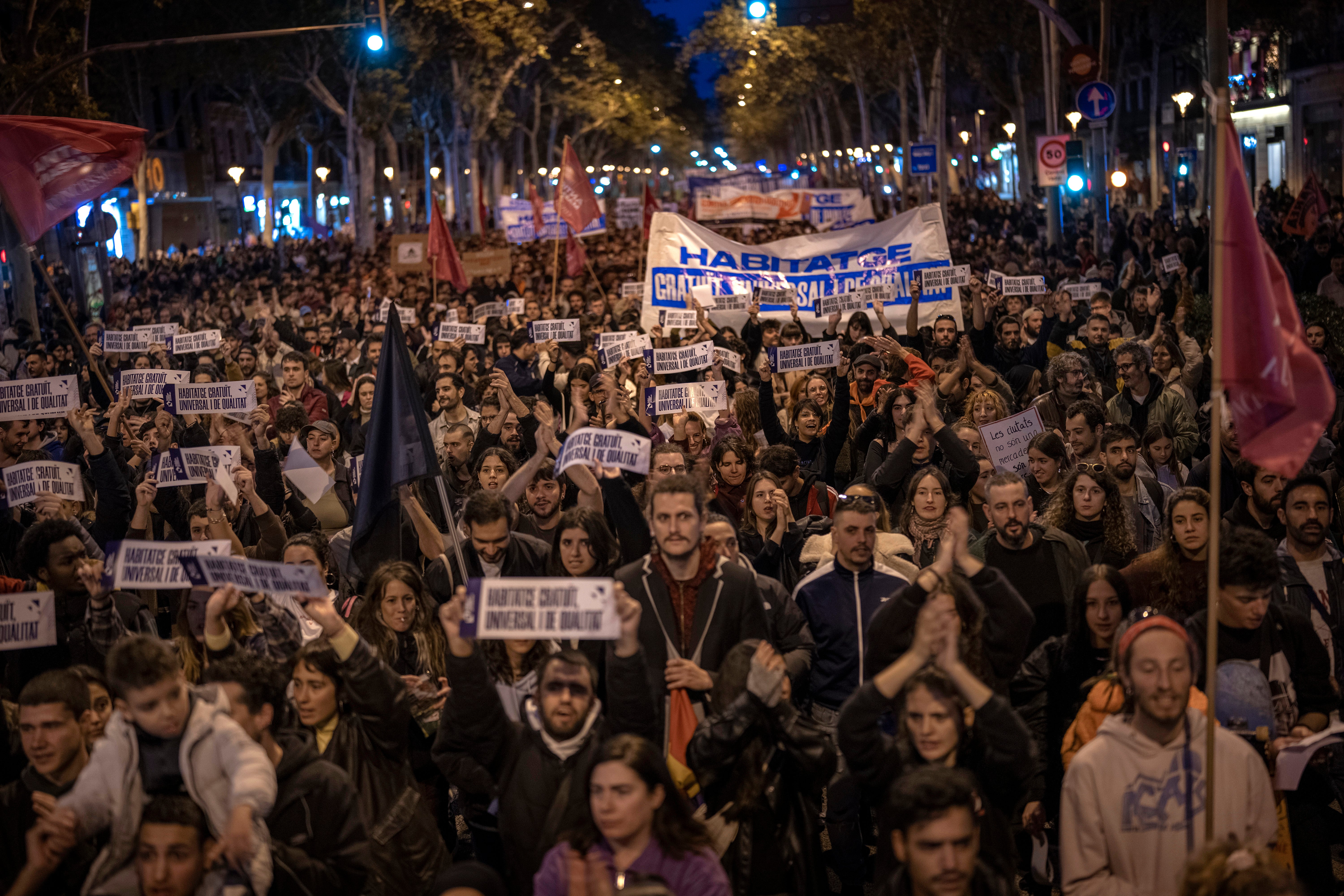 Demonstrators march to protest the skyrocketing cost of renting an apartment in Barcelona