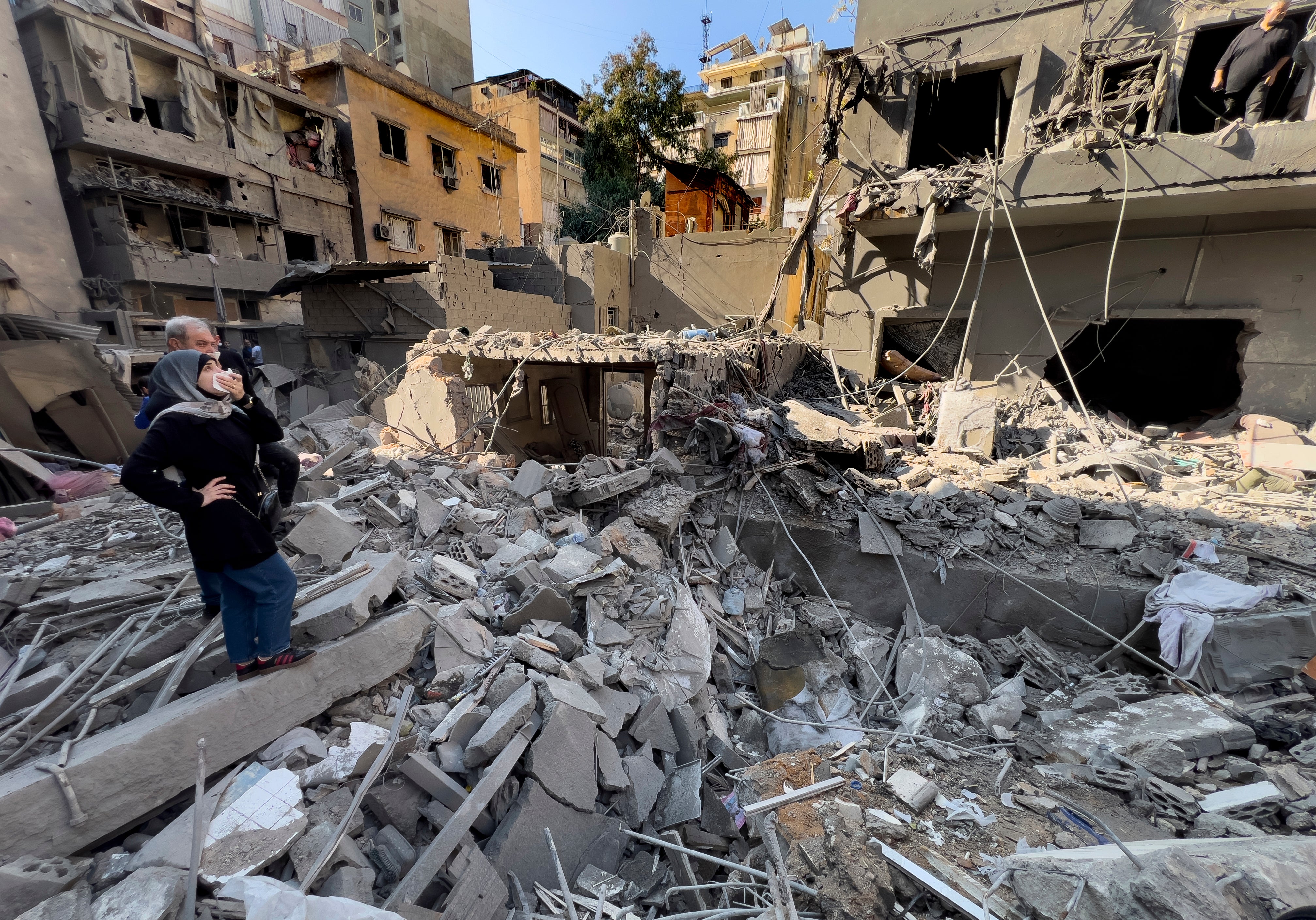 Residents observe the site of an Israeli airstrike that hit central Beirut, Lebanon, on Saturday