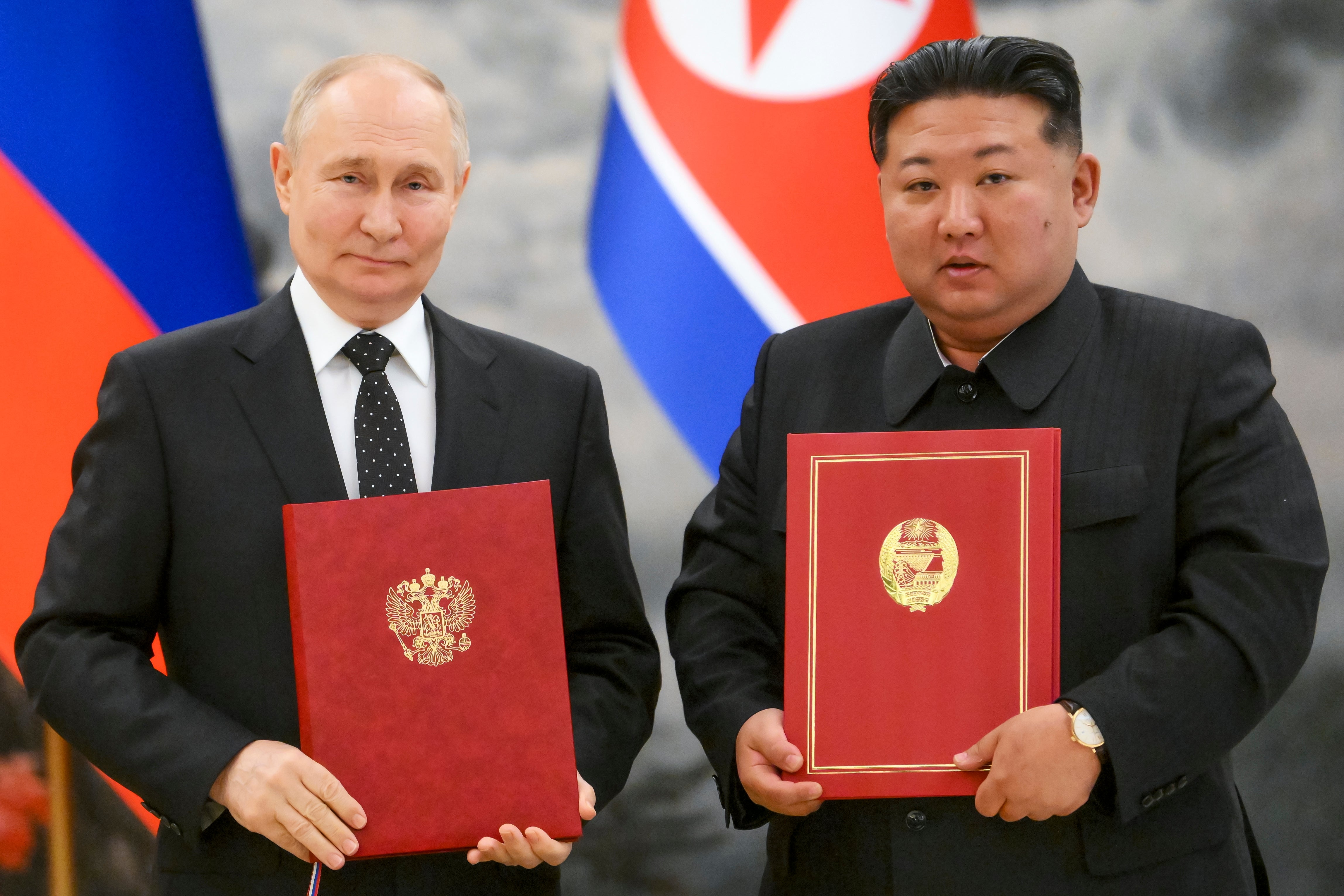 Russian President Vladimir Putin, left, and North Korea's leader Kim Jong Un pose for a photo during a signing ceremony of the new partnership in Pyongyang, North Korea, on June 19, 2024