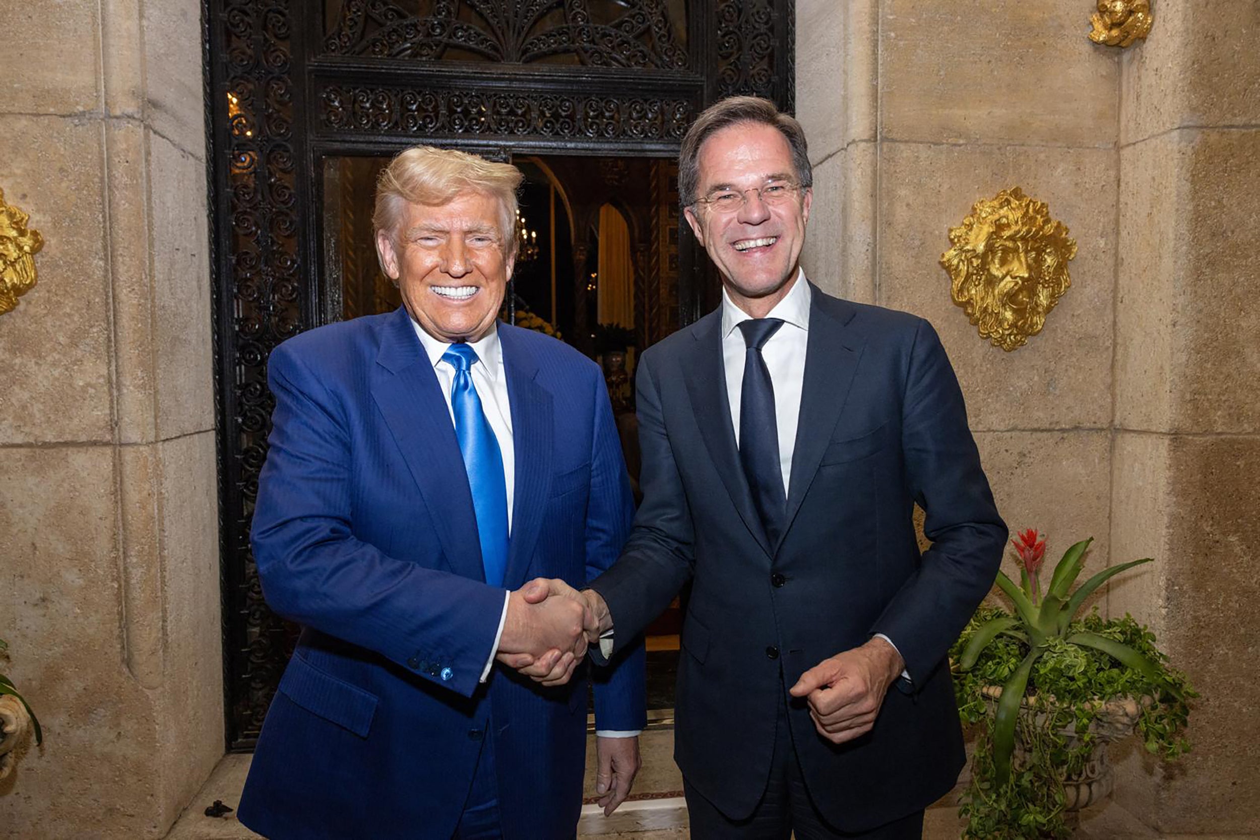 US President-elect Donald Trump (L) shaking hands with NATO Secretary General Mark Rutte as they meet in Palm-Beach, Florida