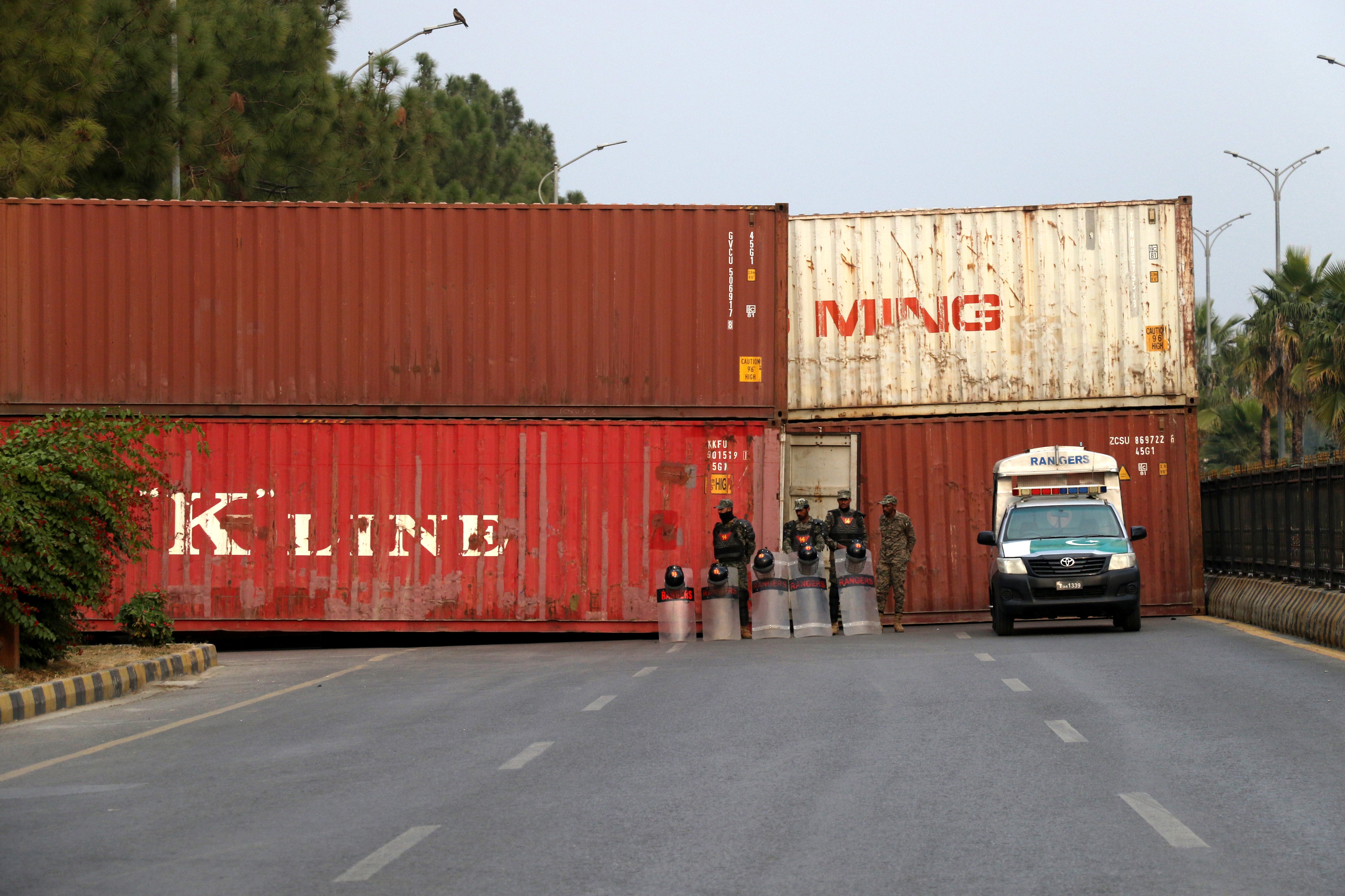 Shipping containers are placed to block a road in Islamabad ahead of a rally to demand the release of former prime minister Imran Khan