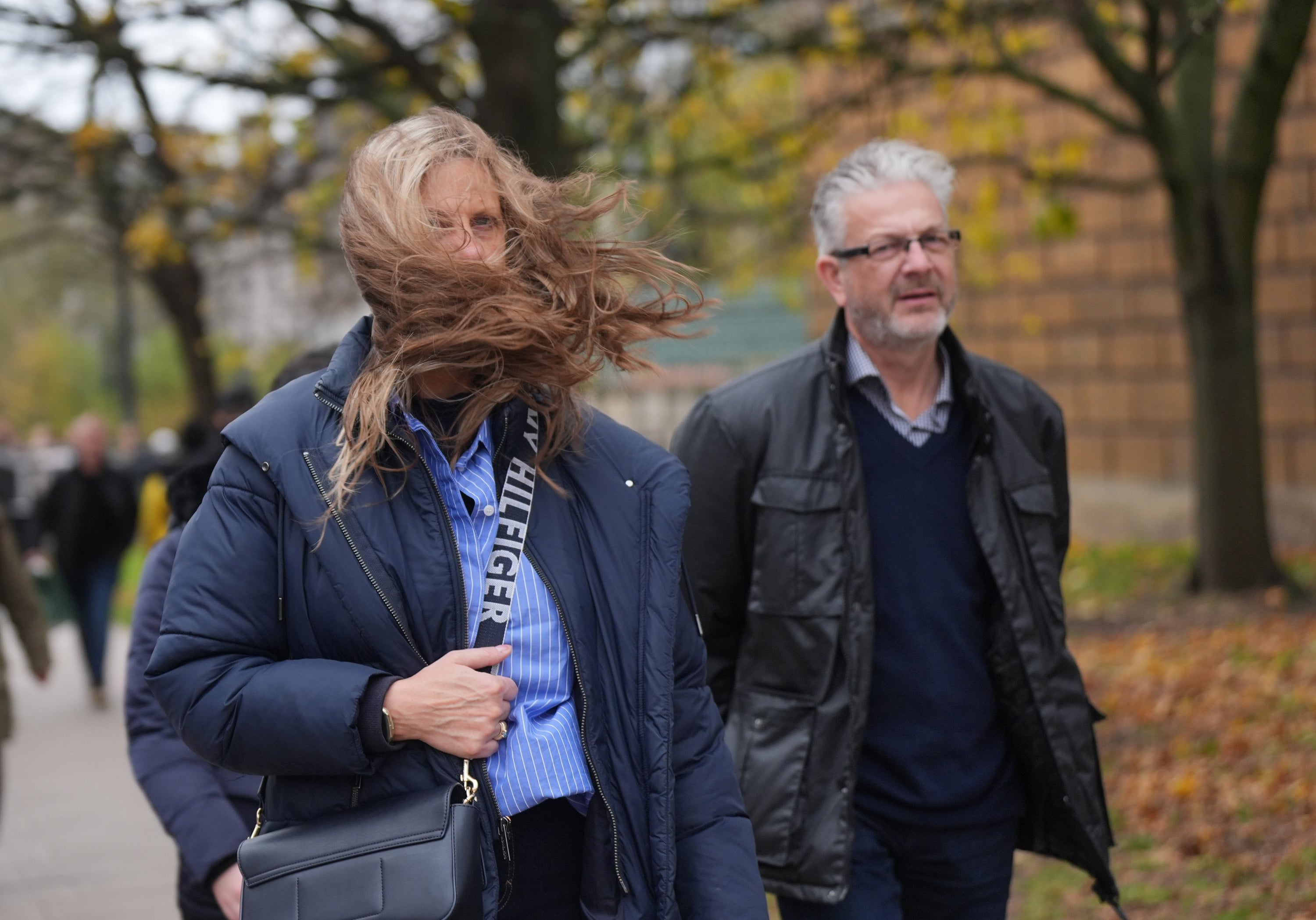 A woman's hair is caught in the wind near Hyde Park in London, which has been closed to the public during Storm Bert