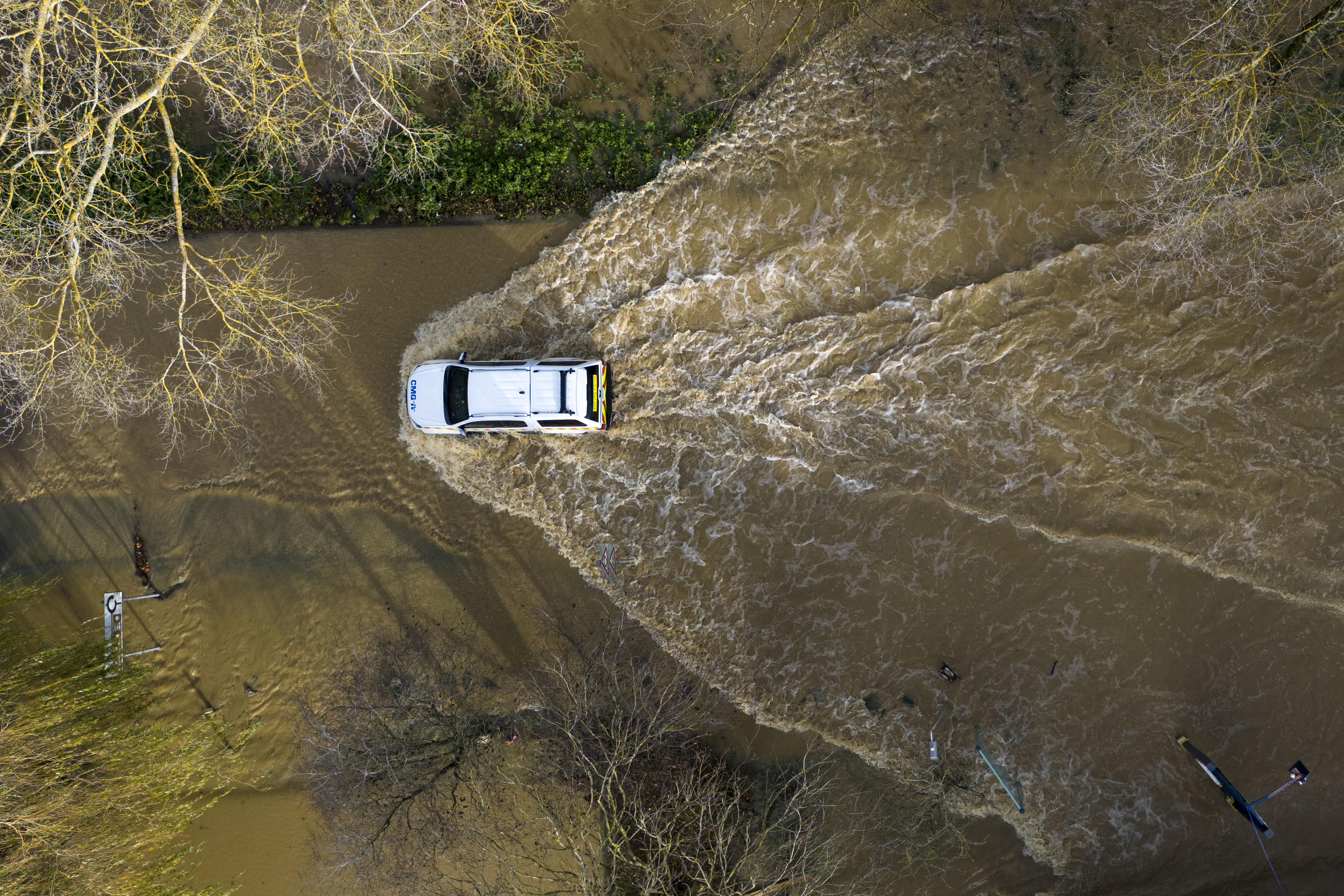 A car drives through floodwater at the Billing Aquadrome in Northamptonshire (Jordan Pettitt/PA)