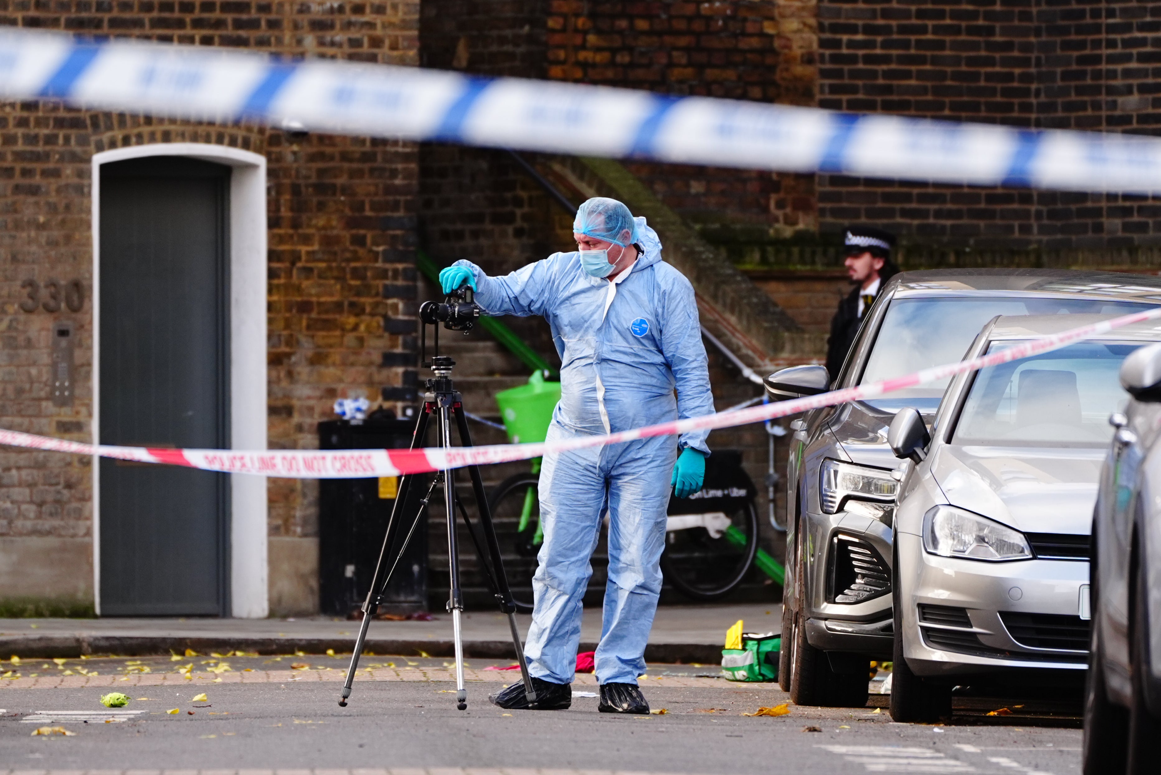 A police forensic officer at the scene on Southern Grove in Ladbroke Grove, west London