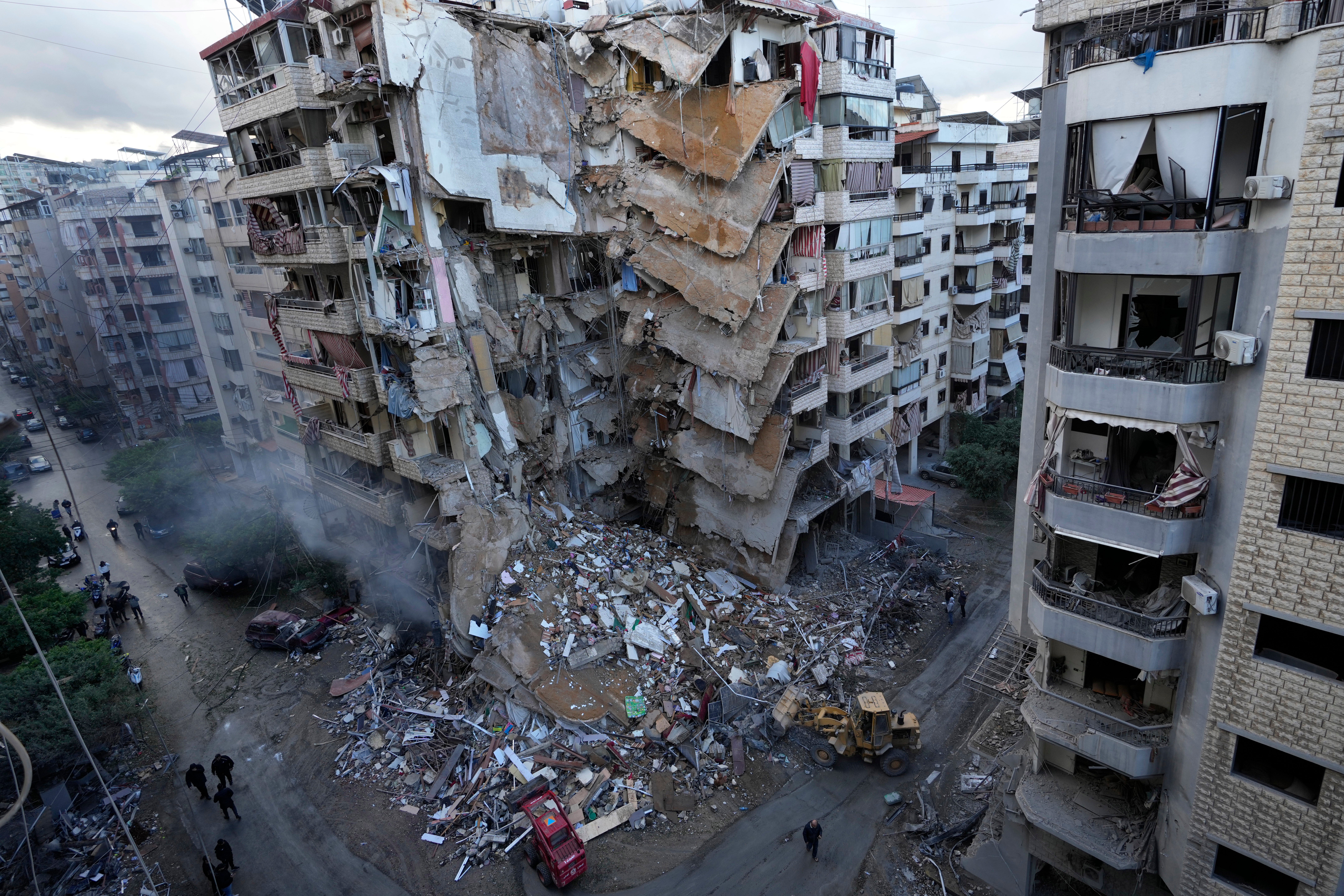 Bulldozers remove the rubble from a building that was hit on Sunday night in an Israeli airstrike in Dahiyeh, in the southern suburbs of Beirut