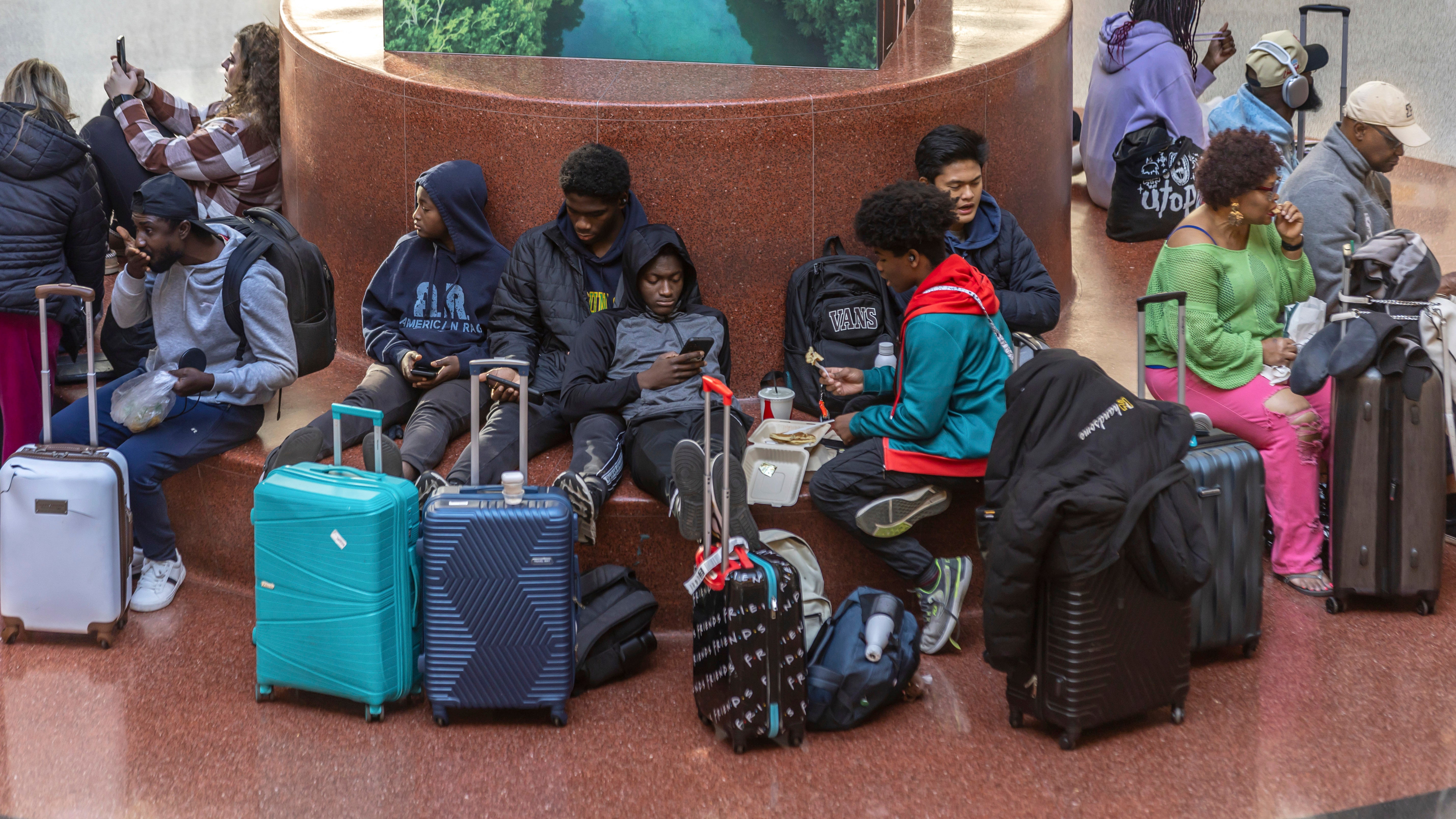 Travelers wait at Hartsfield-Jackson International Airport, Friday, Nov. 22, 2024, in Atlanta, as the Thanksgiving travel season kicks off.
