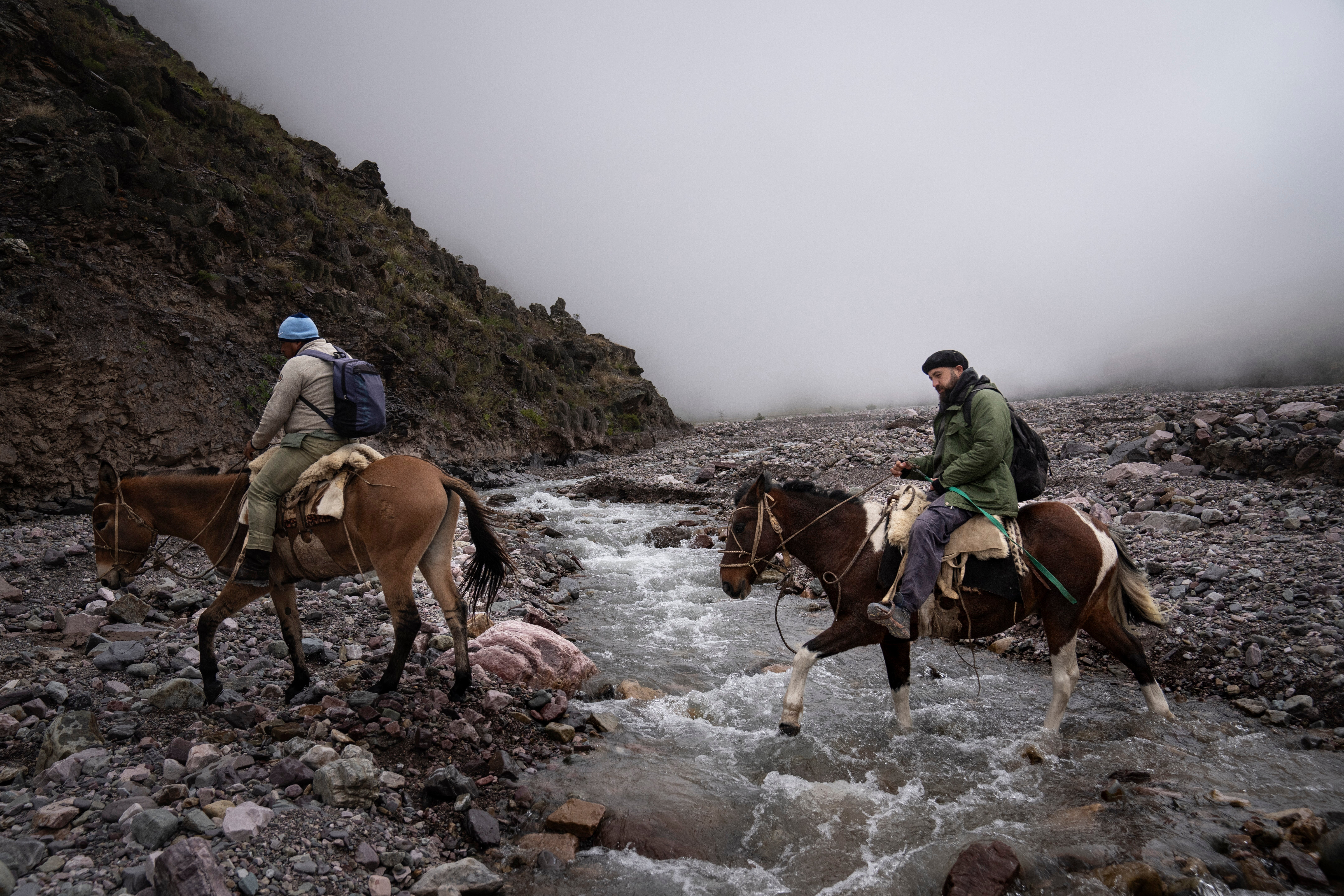 Public health agent Santos Ramos guides Dr. Jorge Fusaro on rented mules through the rocky terrain of the Cerro Chañ