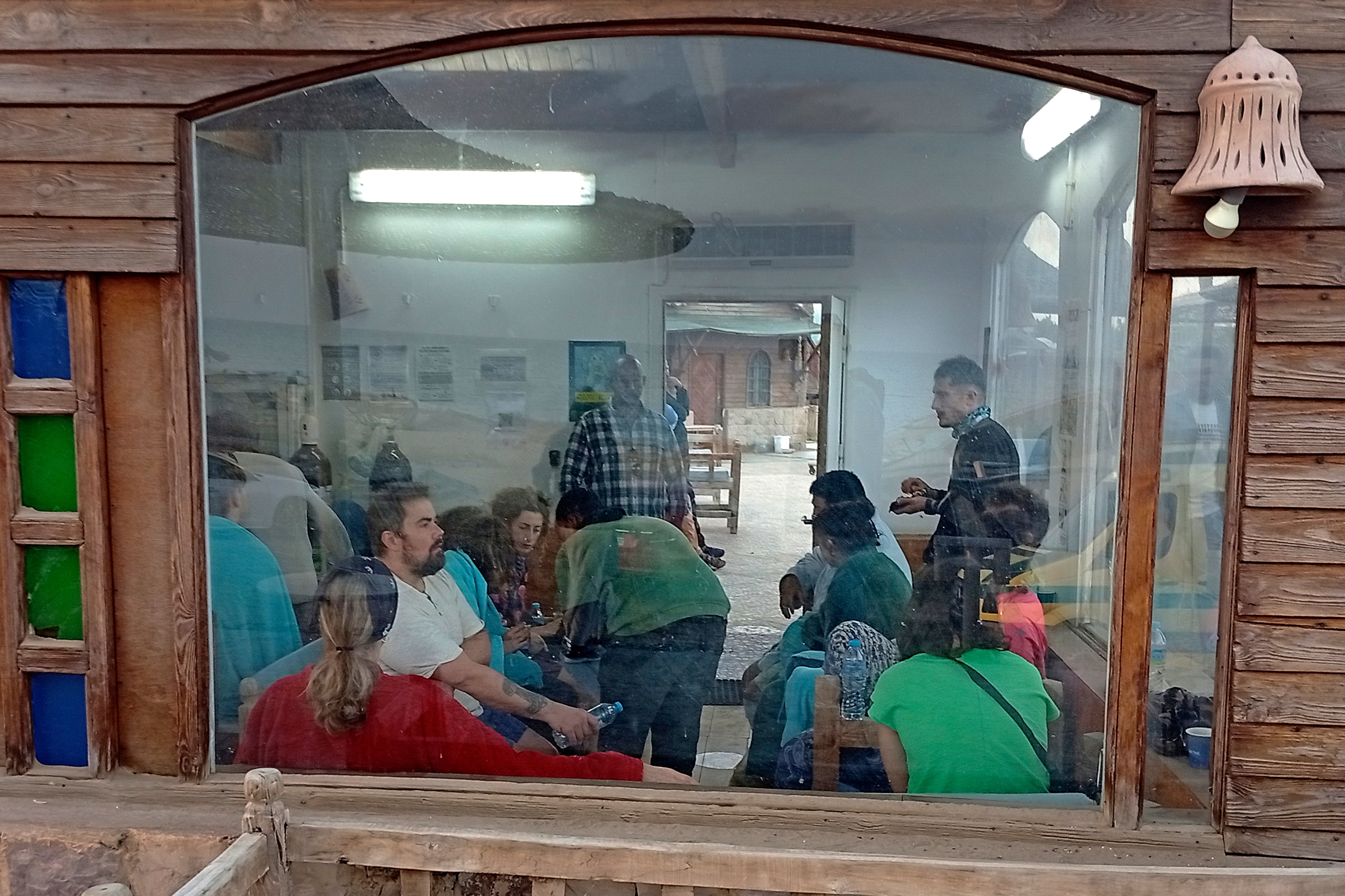 Survivors sit and talk in a cafe after being rescued from the boat which was hit by a ‘huge wave’ on Monday morning