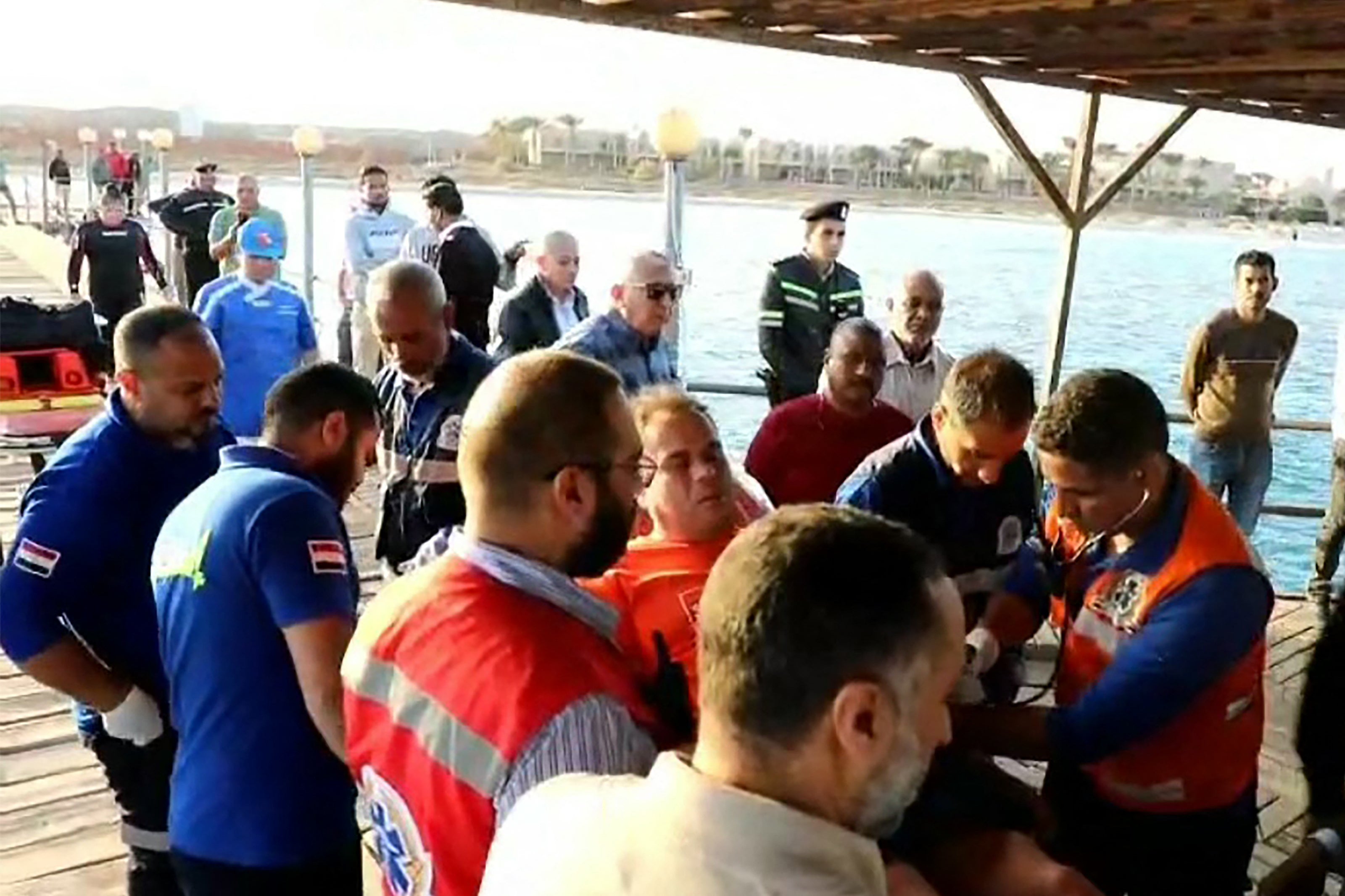 This handout picture released by the Egyptian State Information Service shows first-responders tending to a man on a stretcher in the Red Sea harbour town of Marsa Alam on 25 November 2024