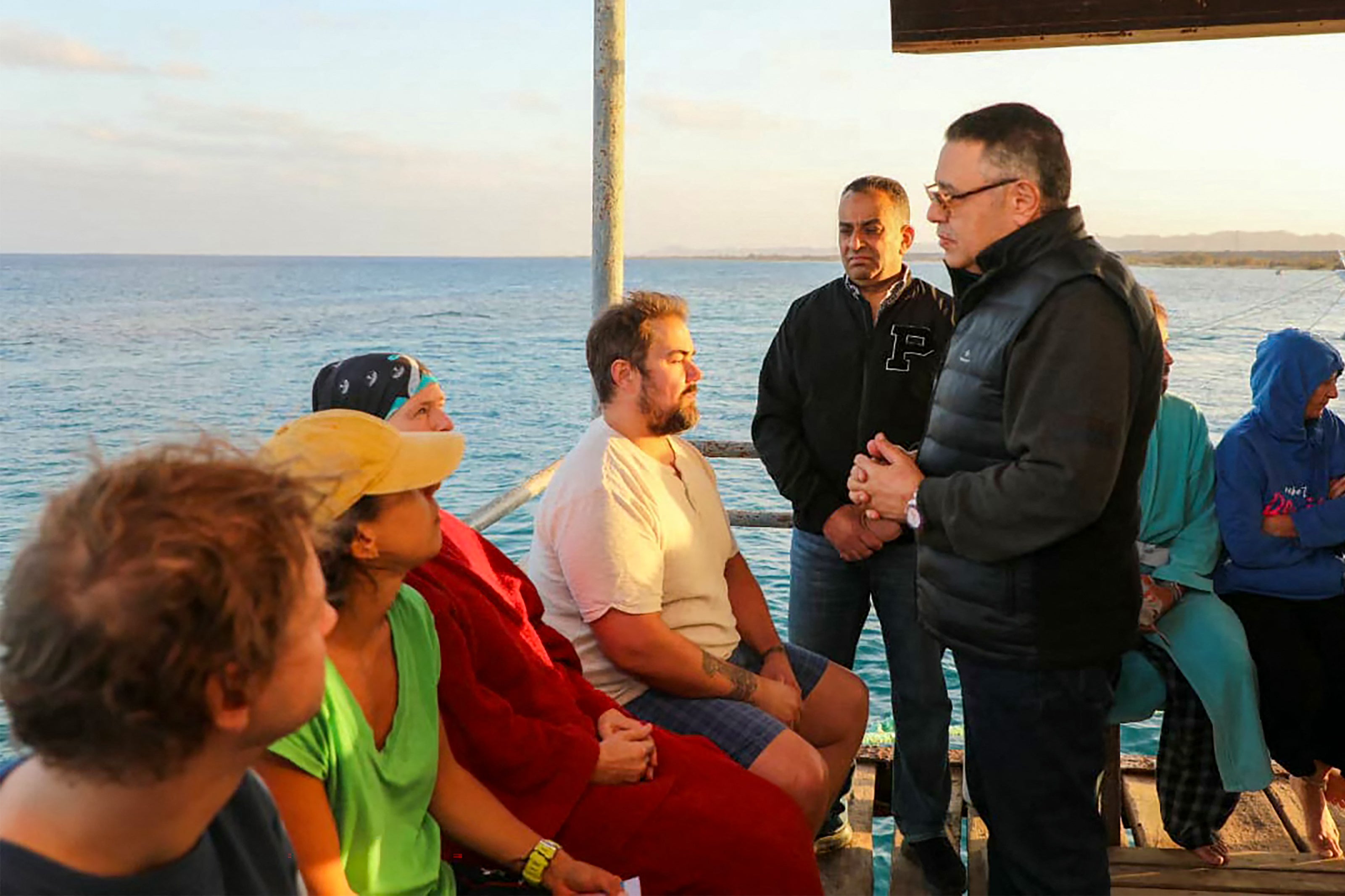 Red Sea governor Amr Hanafi speaking to survivors rescued from a capsized vessel