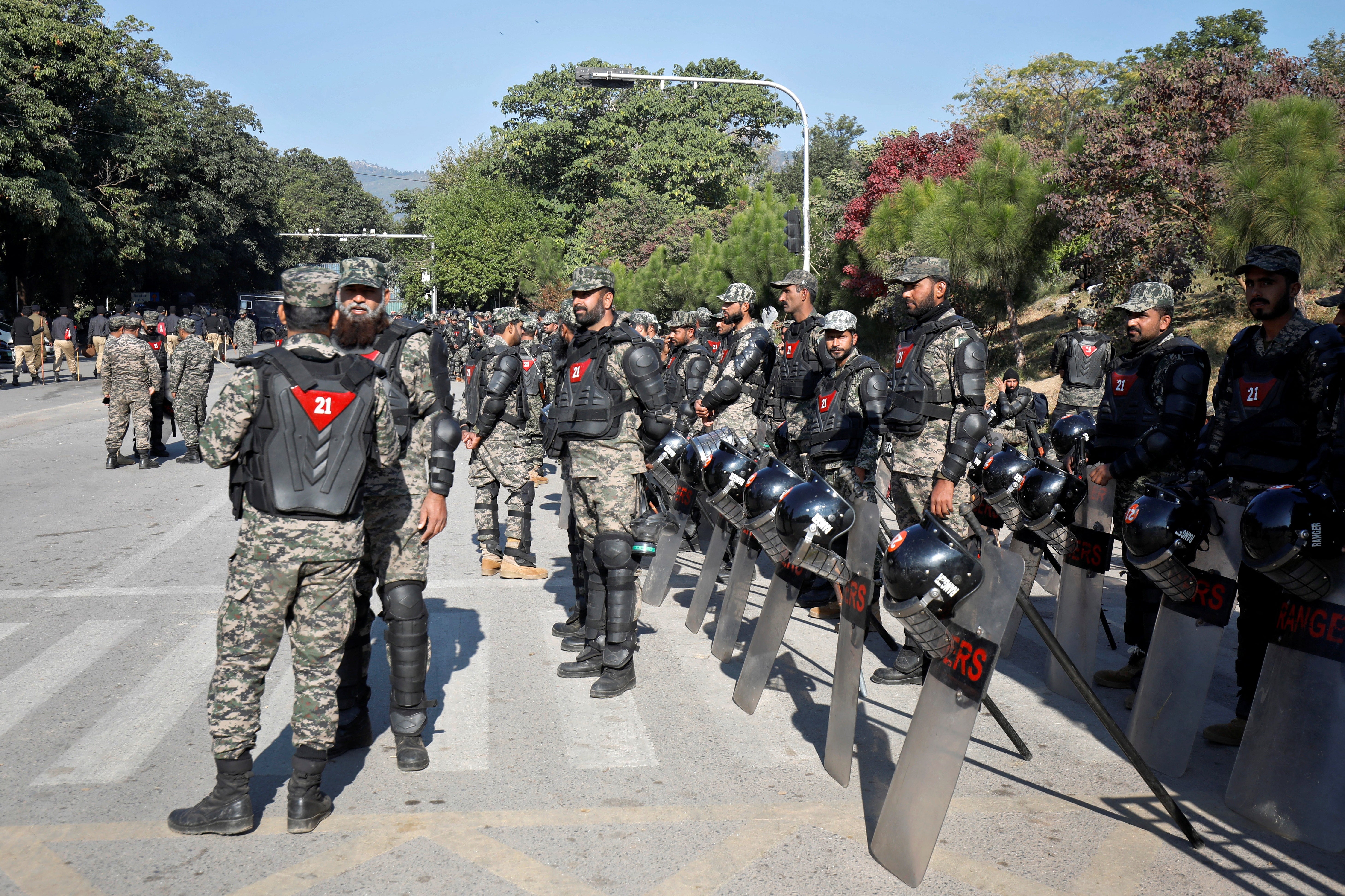 Pakistani Rangers in riot gear stand guard to prevent an anti-government rally, in Islamabad