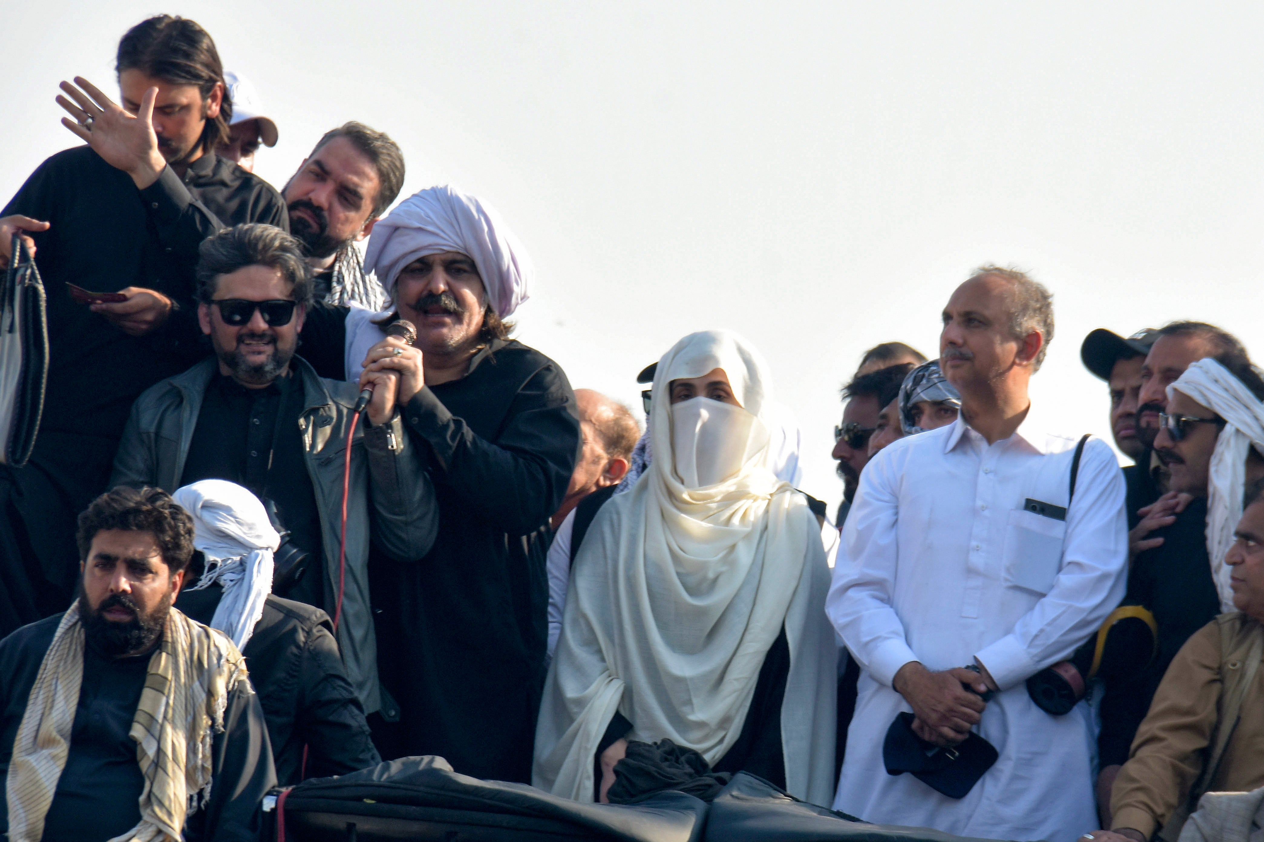 Bushra Bibi, center, wife of imprisoned former premier Imran Khan and leaders of Khan's party lead their supporters during a rally demanding Khan's release