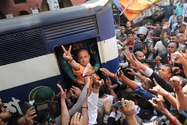 <p>Bangladeshi Hindu leader Krishna Das Prabhu shows a victory sign as he is taken in a police van after court ordered him detained pending further proceedings in Chattogram</p>