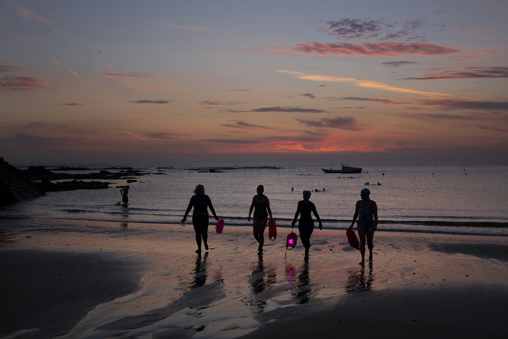 Pre-dawn swimmers at Cullercoats, Tynemouth (Owen Humphreys/PA)