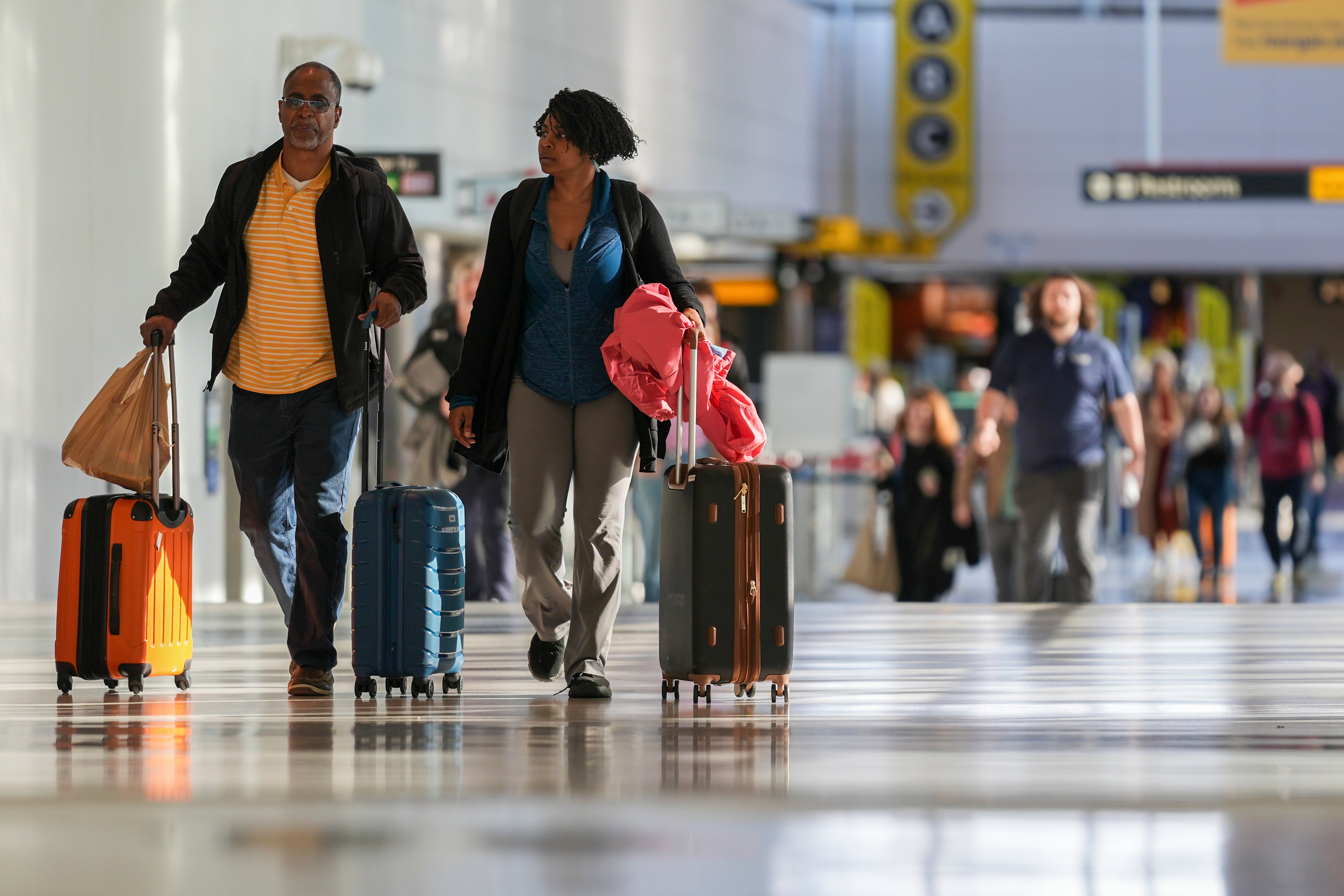 Travelers walk through the Baltimore/Washington International Thurgood Marshall Airport on Monday in Maryland. Post-holiday travel will continue to be tricky with weather systems across the nation on Friday