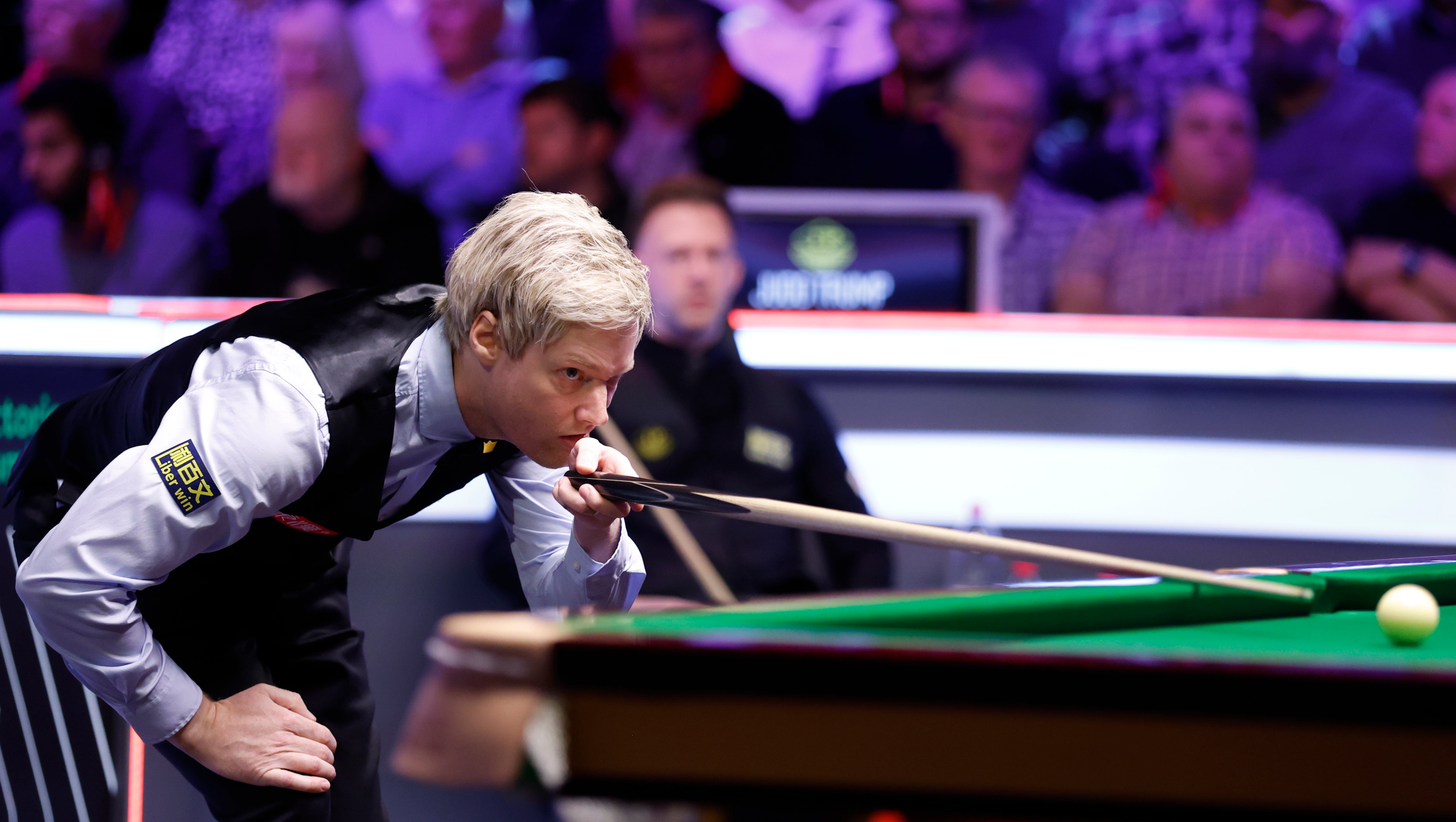 Neil Robertson eyes a shot as Judd Trump watches on