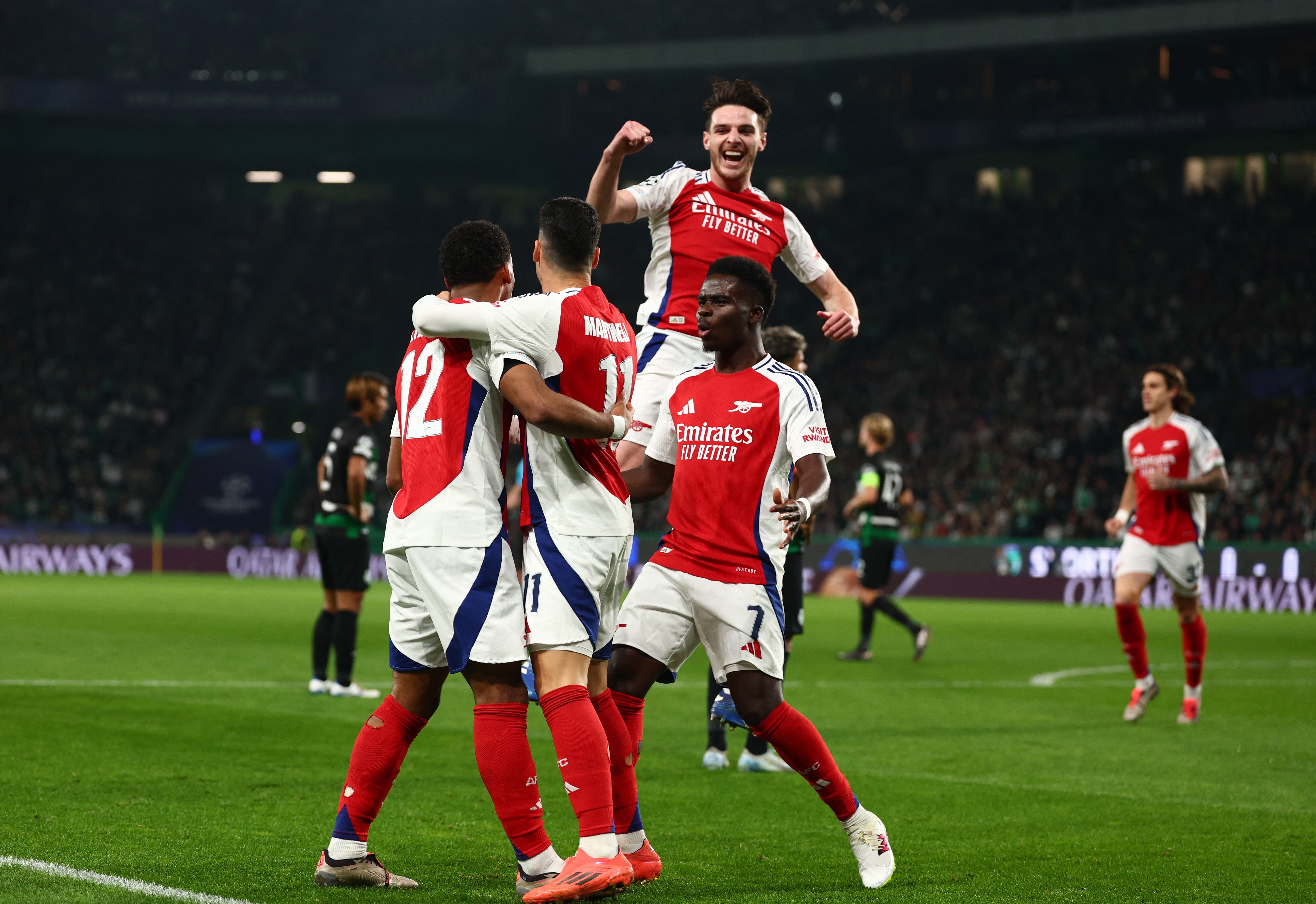 Arsenal players celebrate after scoring the opener