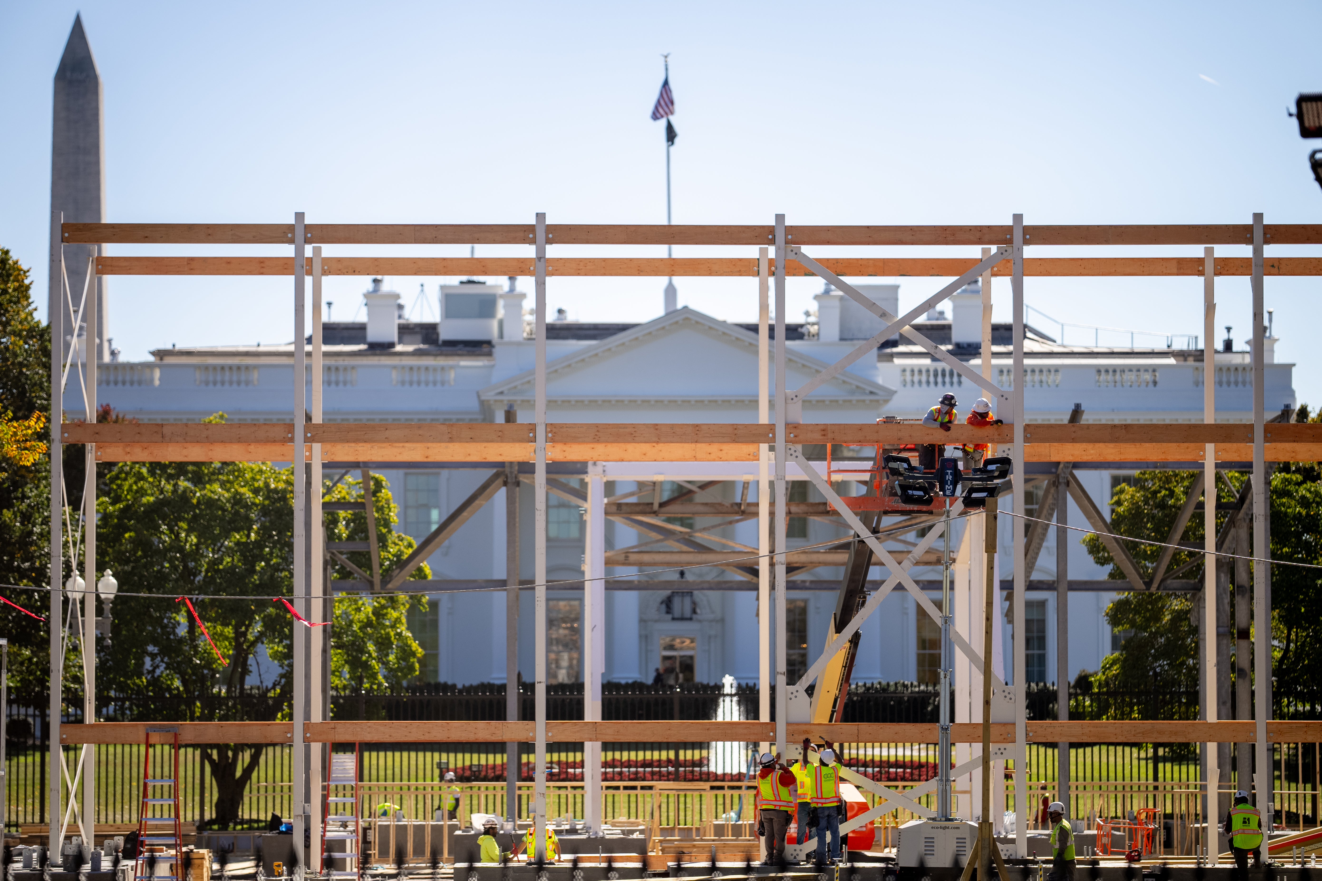 Workers prepare a media riser for the 2025 presidential inauguration outside the White House. Donald Trump has made his disdain for Washington, DC clear, once calling it ‘filthy and crime-ridden'