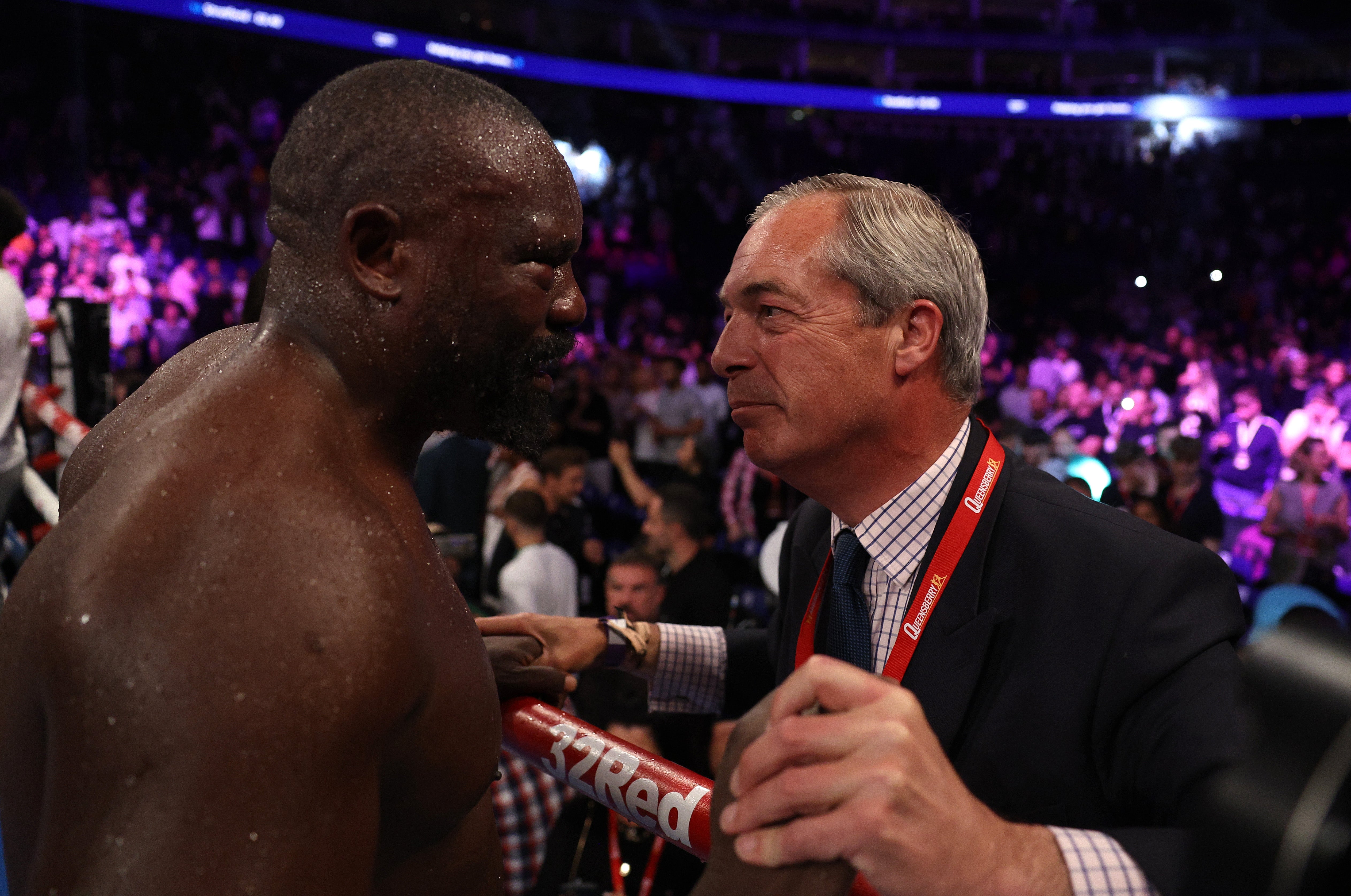 Chisora celebrates with Nigel Farage after beating Joe Joyce on points