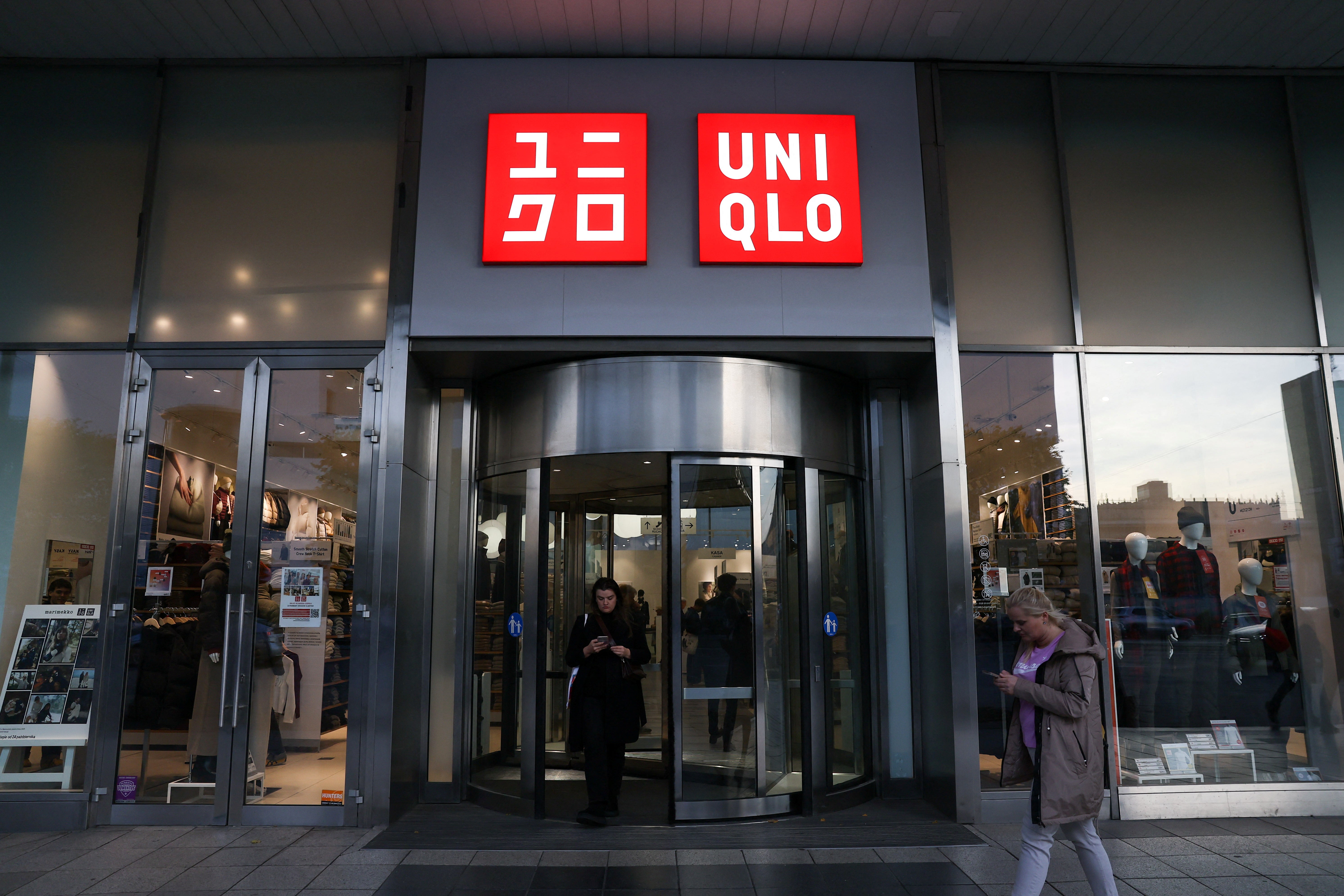 People walk outside Uniqlo store in Warsaw