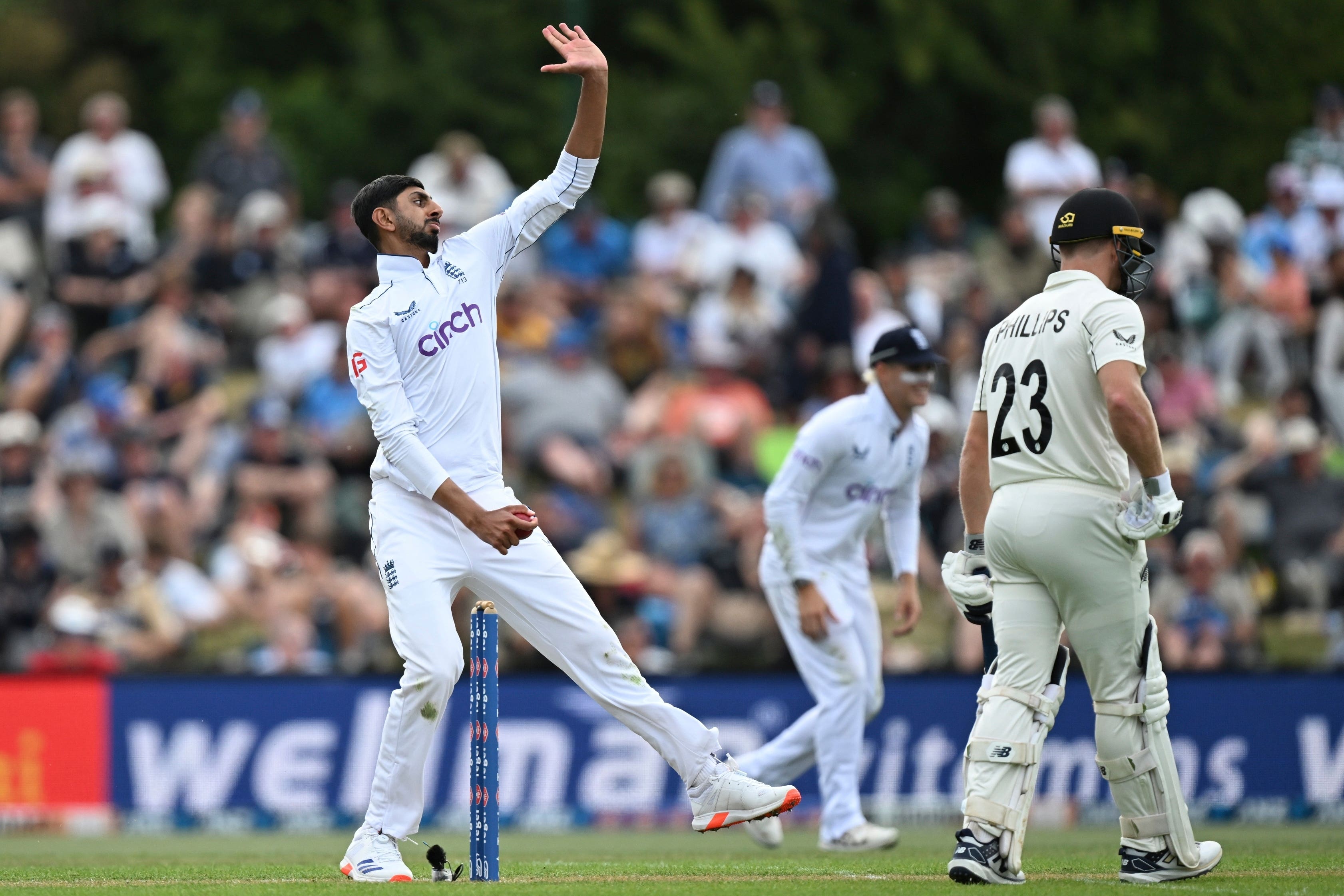 England’s Shoaib Bashir bowls during play on the first day of the first Test between England and New Zealand at Hagley Oval in Christchurch (Andrew Cornaga/Photosport/AP)