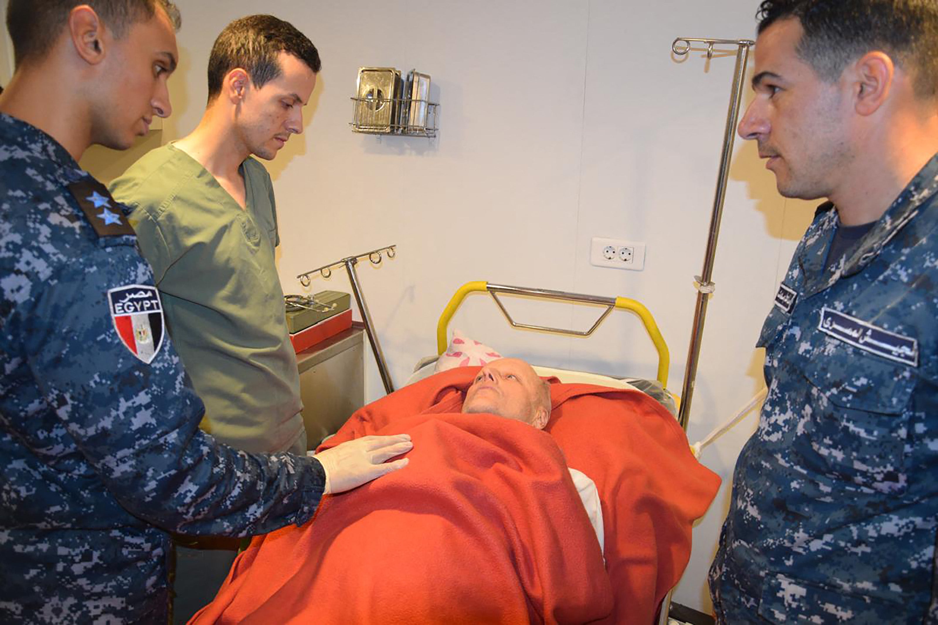 A rescued person is tended to by professionals after being brought to safety