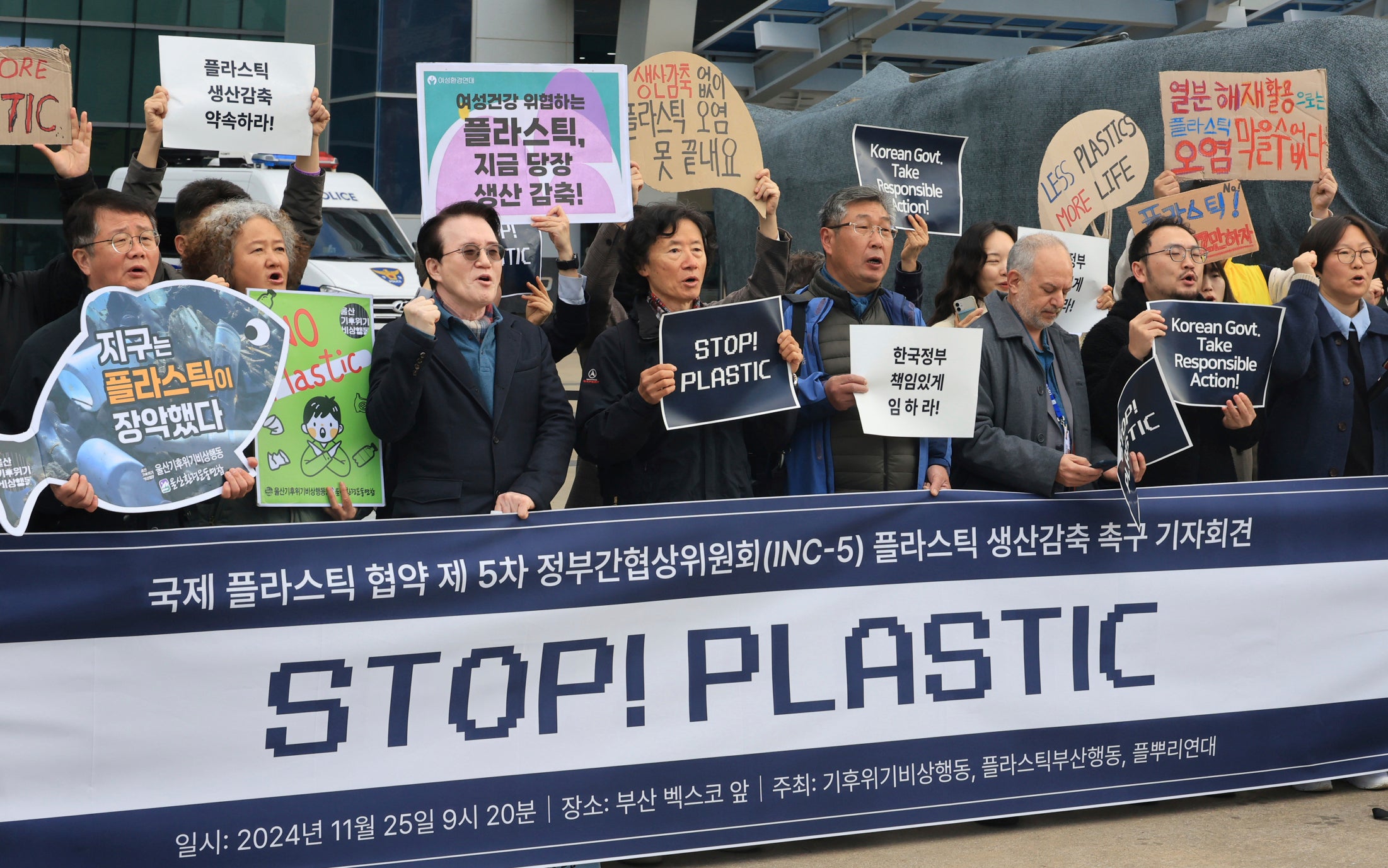 Environment activists shout slogans during the press conference outside of the venue for the fifth session of the Intergovernmental Negotiating Committee on Plastic Pollution in Busan, South Korea