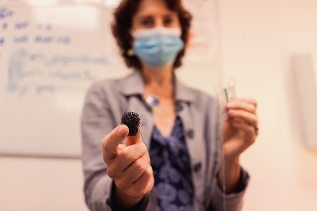 Professor Rebecca Fitzgerald shows off her invention, the capsule sponge test (University of Cambridge/PA)