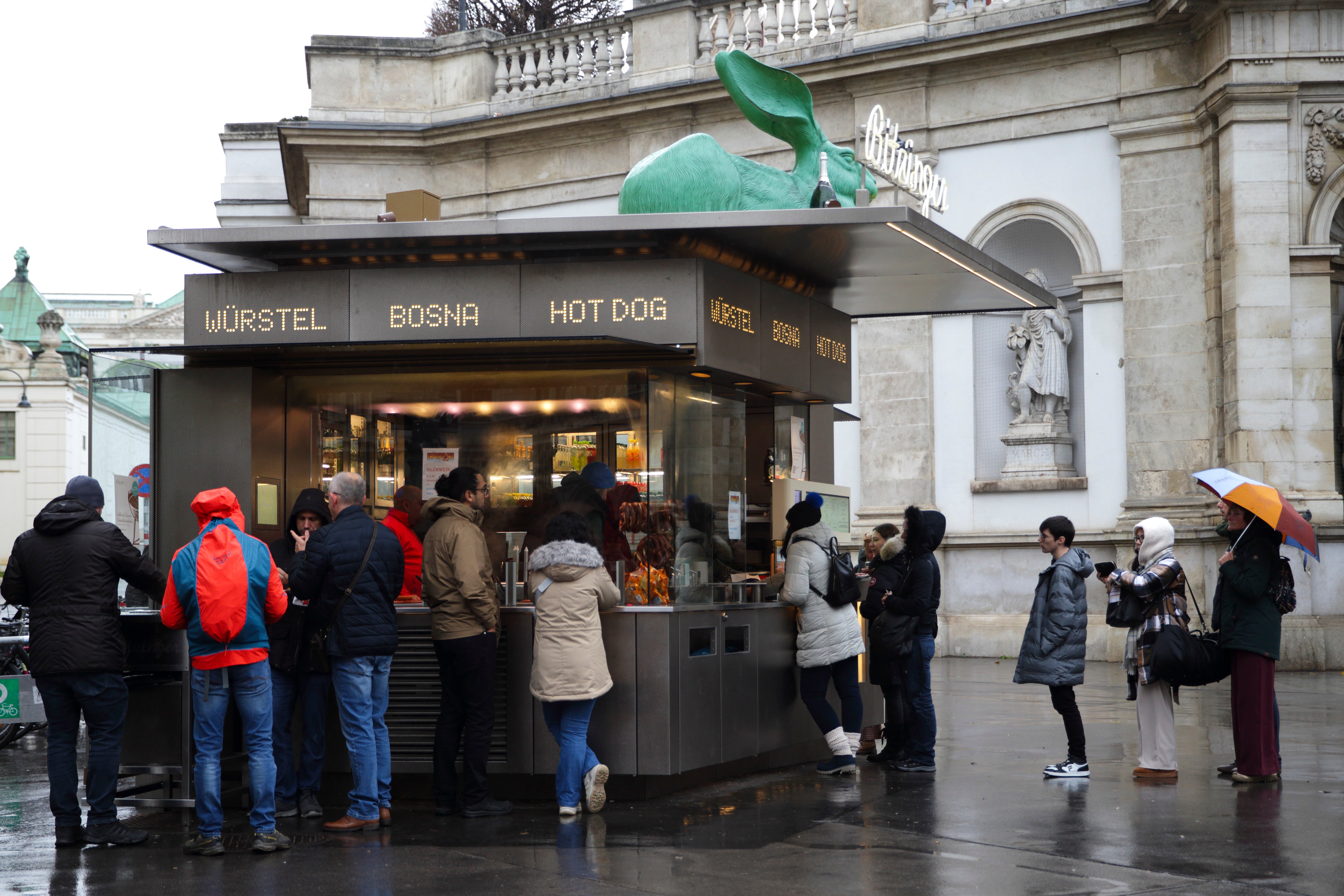 Customers line up at a traditional sausage stand