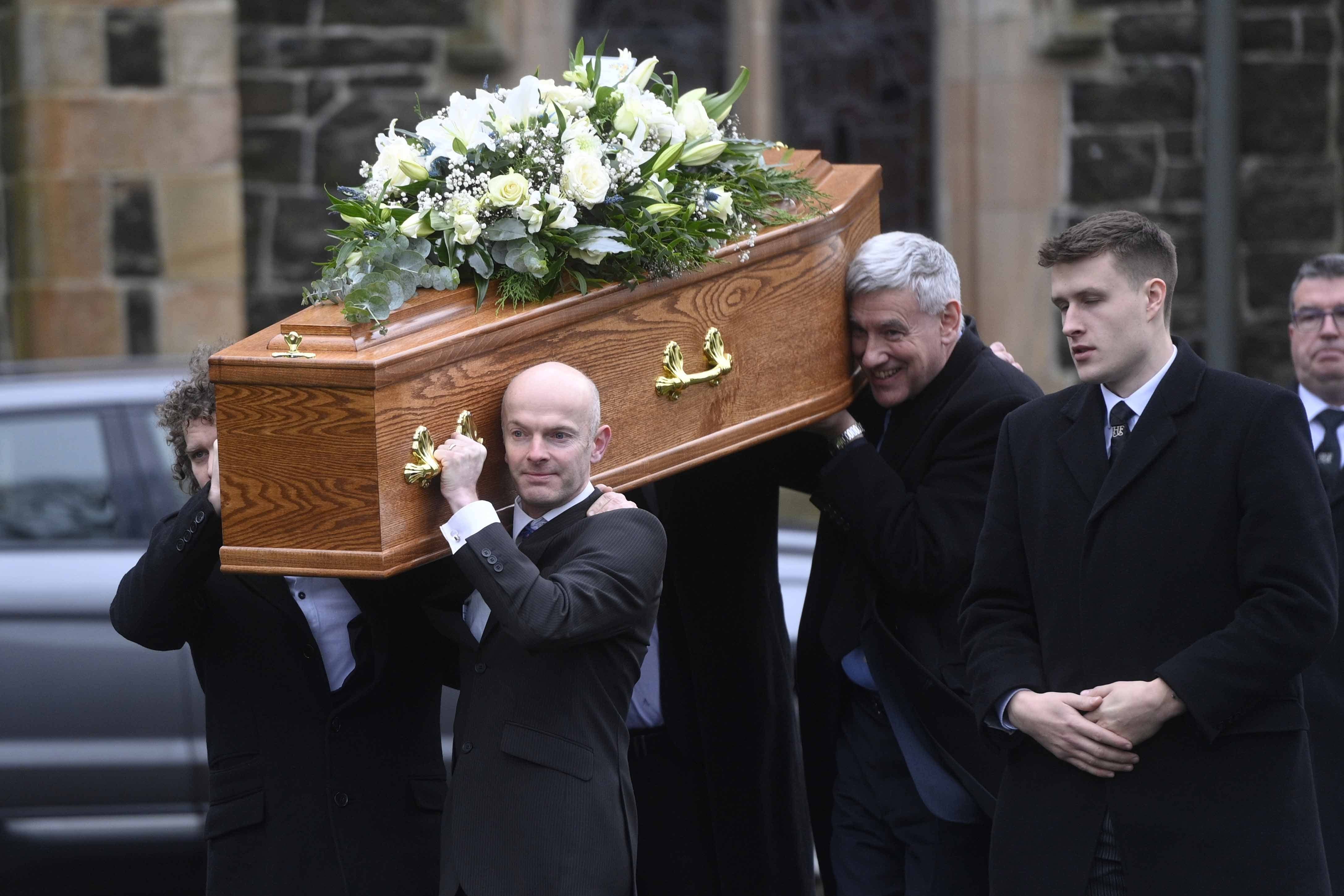 The coffin of veteran journalist and former UTV political editor Ken Reid is carried out of St Patrick’s Church in Ballymena (Mark Marlow/PA)