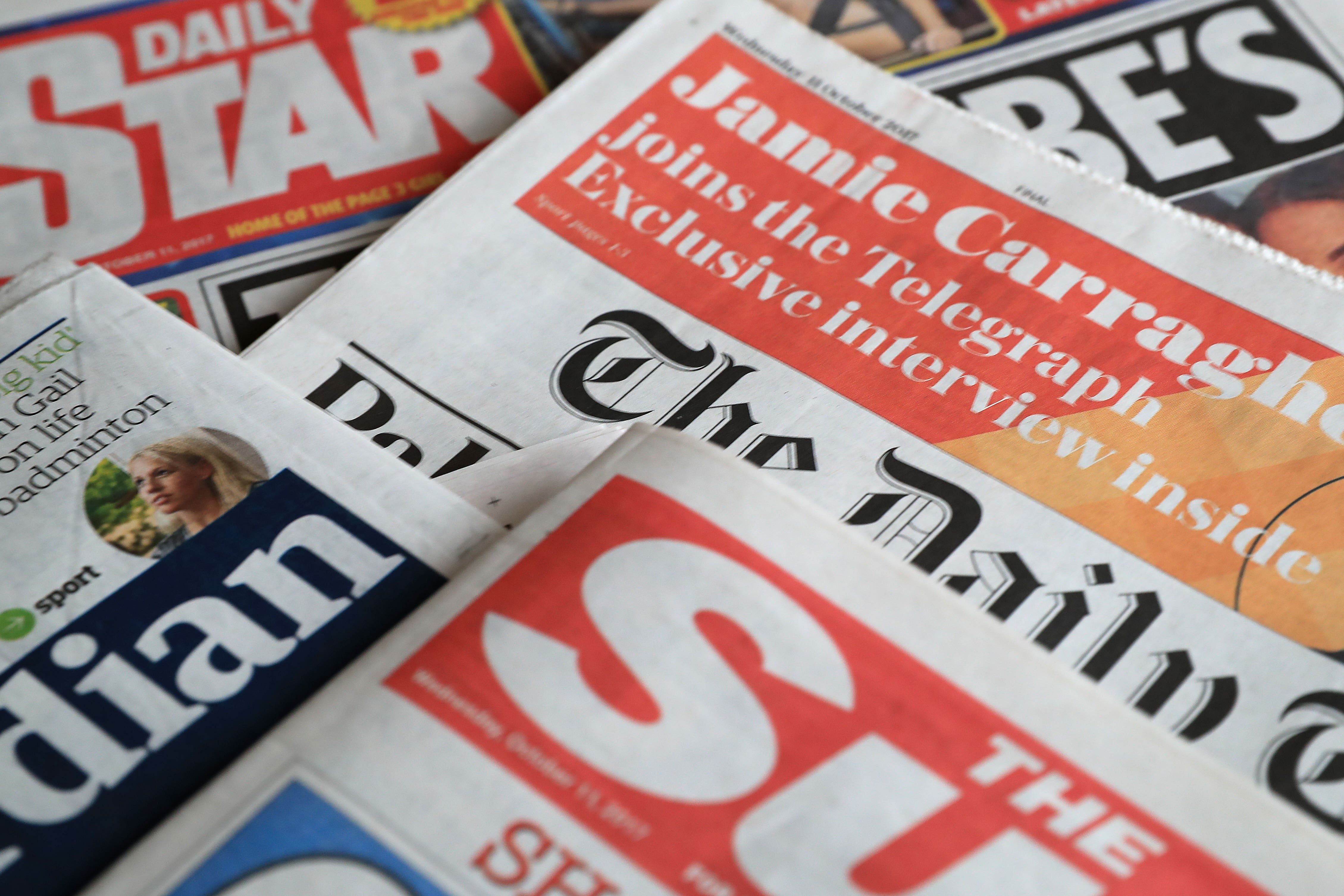 A collection of British newspapers.