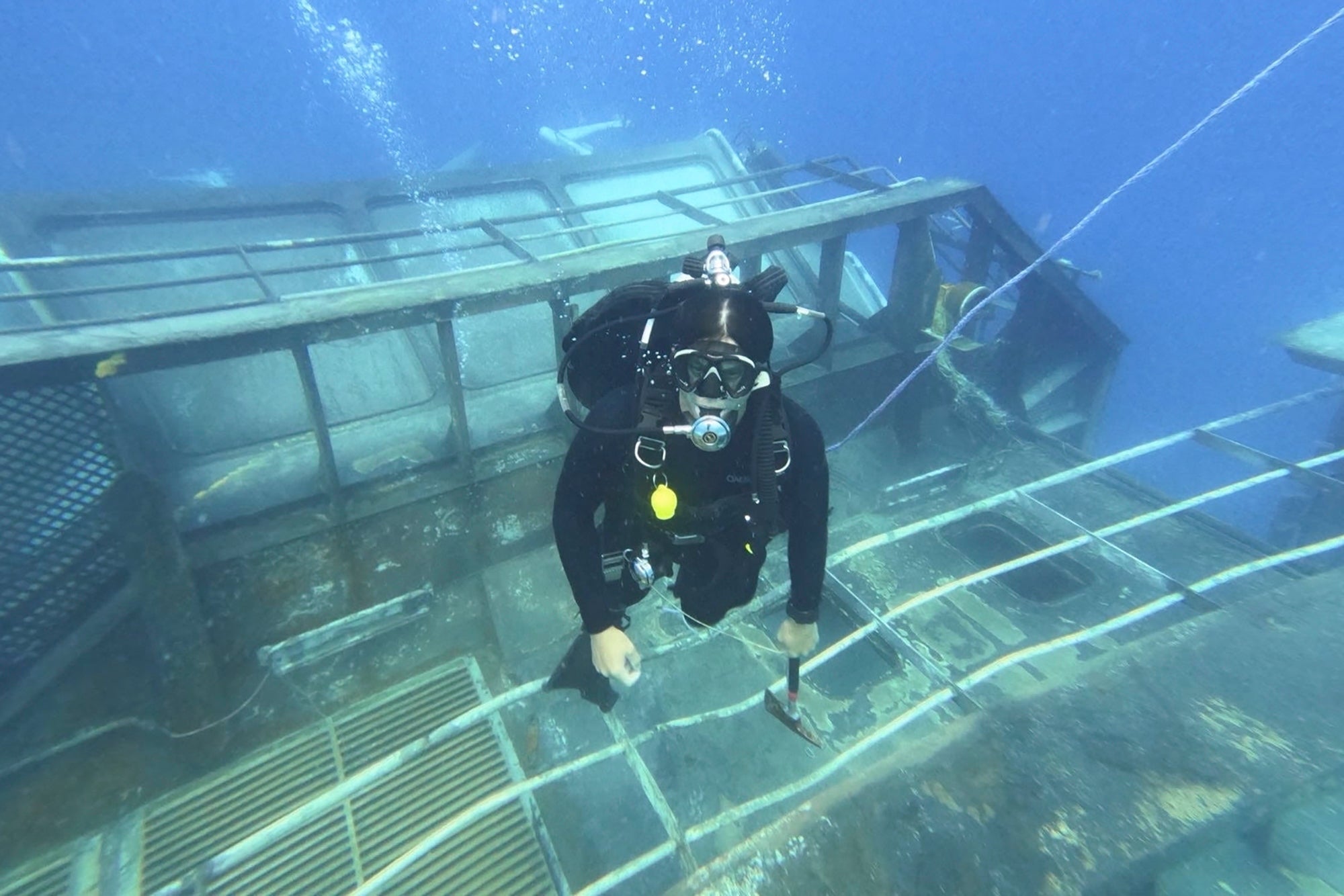 A diver survey’s the HMNZS Manawanui